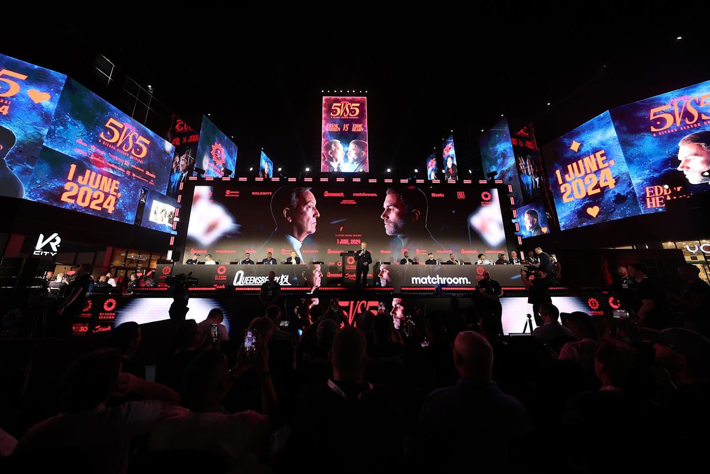 RIYADH, SAUDI ARABIA - MAY 30: A general view inside the venue as Michael Buffer, American Ring Announcer, addresses the crowd during the Queensbury v Matchroom 5v5 Press Conferences at Boulevard World on May 30, 2024 in Riyadh, Saudi Arabia. (Photo by Richard Pelham/Getty Images)