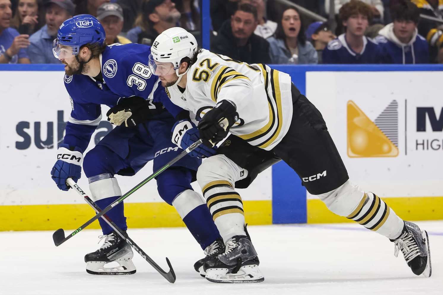 TAMPA, FL - MARCH 27: Brandon Hagel #38 of the Tampa Bay Lightning against Andrew Peeke #52 of the Boston Bruins during the third period at Amalie Arena on March 27, 2024 in Tampa, Florida. (Photo by Mark LoMoglio/NHLI via Getty Images)