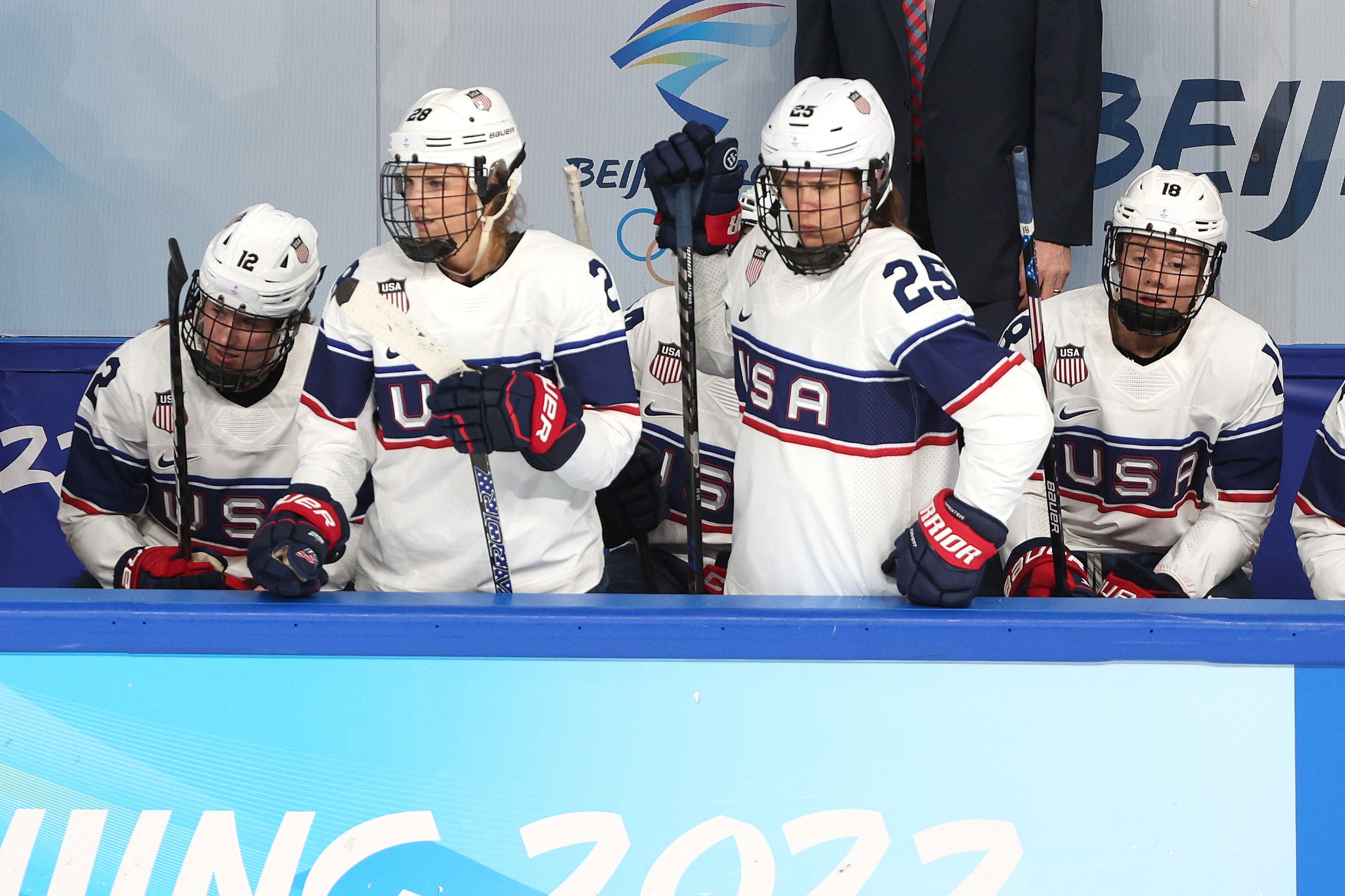 BEIJING, CHINA - FEBRUARY 17: (L-R) Kelly Pannek #12, Amanda Kessel #28, Alex Carpenter #25 and Jesse Compher #18 of Team United States look on from the bench area after Team Canada scored their second goal in the first period during the Women's Ice Hockey Gold Medal match between Team Canada and Team United States on Day 13 of the Beijing 2022 Winter Olympic Games at Wukesong Sports Centre on February 17, 2022 in Beijing, China. (Photo by Harry How/Getty Images)