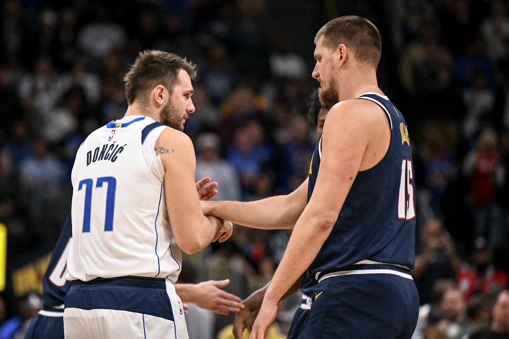 DENVER, CO - NOVEMBER 10: Nikola Jokic (15) of the Denver Nuggets jokes with Luka Doncic (77) of the Dallas Mavericks during the first quarter at Ball Arena in Denver, Colorado on Sunday, November 10, 2024. (Photo by AAron Ontiveroz/The Denver Post)