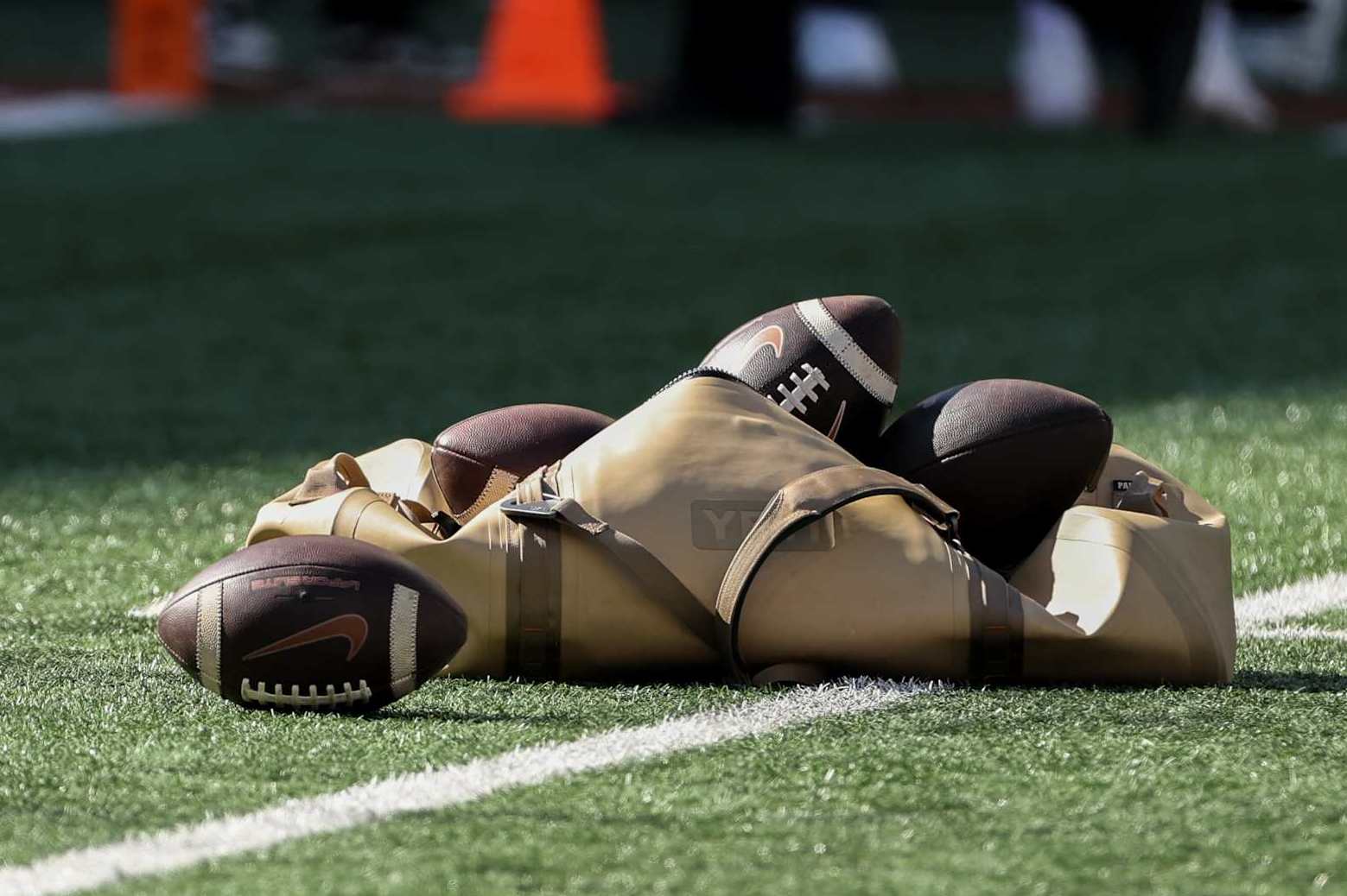 AUSTIN, TX - NOVEMBER 23: A Yeti bag of Texas logo footballs sits on the field before the SEC college football game between Texas Longhorns and Kentucky Wildcats on November 23, 2024, at Darrell K Royal - Texas Memorial Stadium in Austin, TX. (Photo by David Buono/Icon Sportswire via Getty Images)