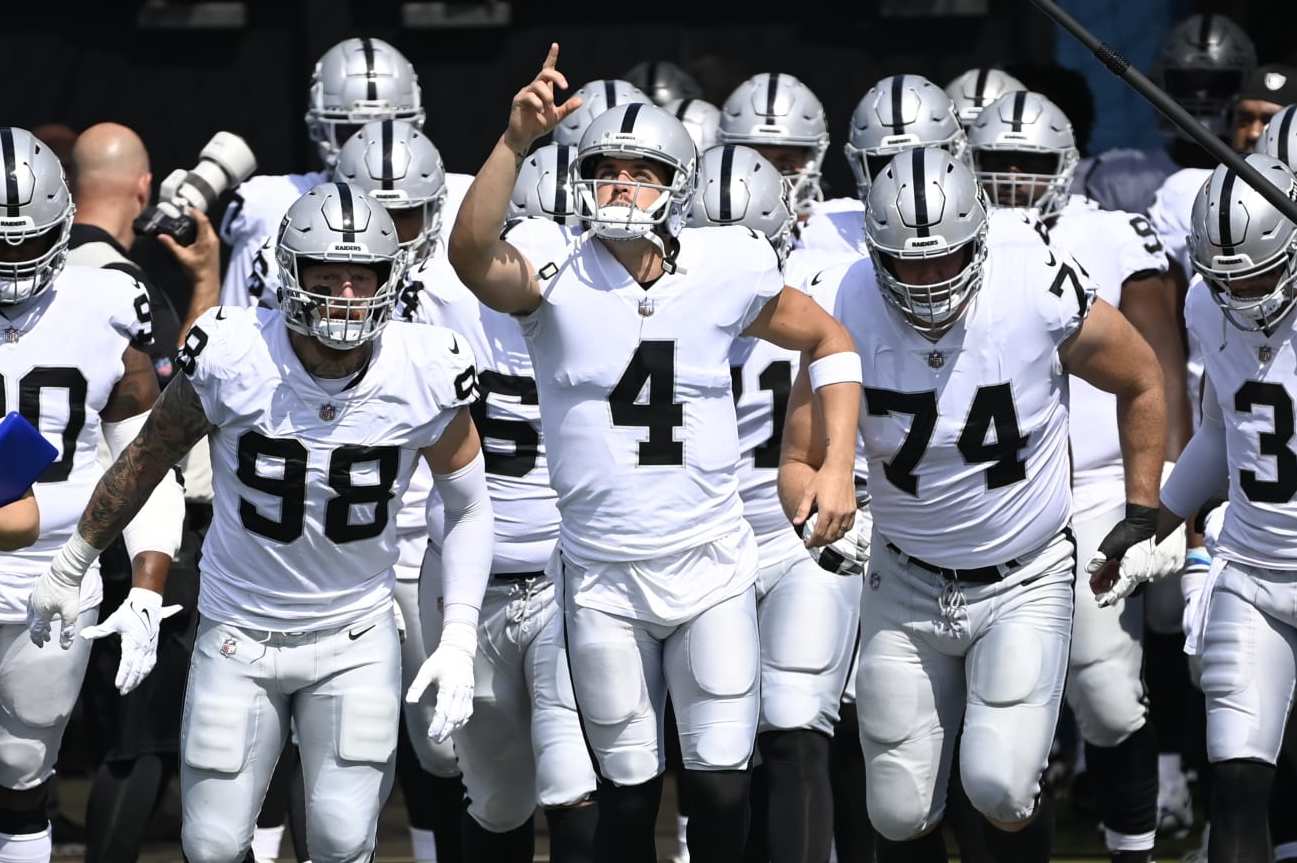 Las Vegas Raiders quarterback Derek Carr (4) leads his team onto the field for the first half of an NFL football game against the Tennessee Titans Sunday, Sept. 25, 2022, in Nashville, Tenn. (AP Photo/Mark Zaleski)