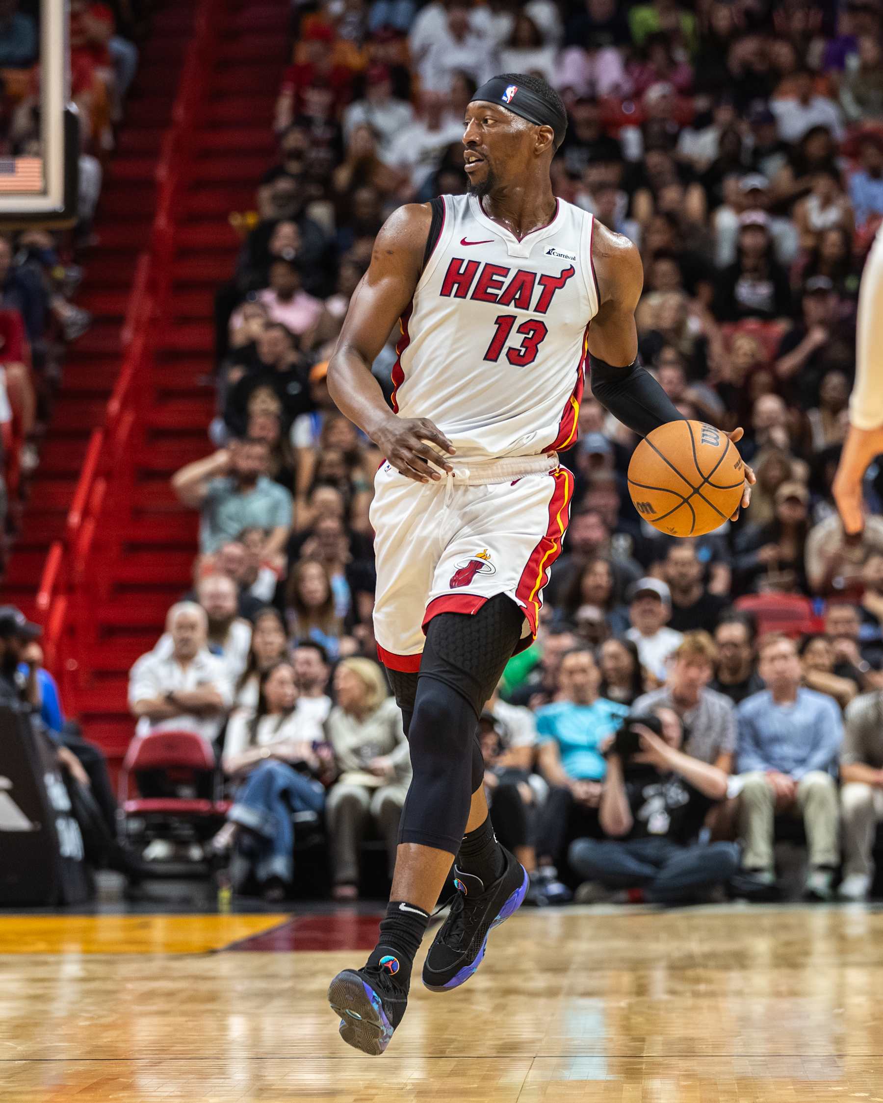 MIAMI, FLORIDA - MARCH 29: Bam Adebayo #13 of the Miami Heat dribbles the ball against the Portland Trail Blazers during the second half at the Kaseya Center on March 29, 2024 in Miami, Florida. NOTE TO USER: User expressly acknowledges and agrees that, by downloading and or using this photograph, User is consenting to the terms and conditions of the Getty Images License Agreement.  (Photo by Lauren Sopourn/Getty Images)