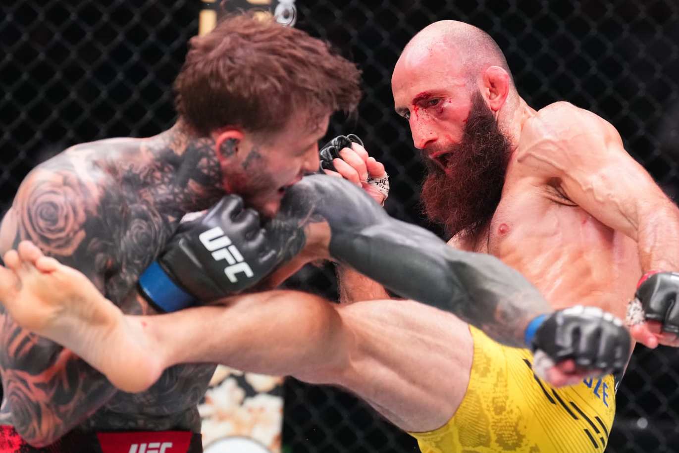 ABU DHABI, UNITED ARAB EMIRATES - AUGUST 03: (R-L) Guram Kutateladze of Georgia kicks Jordan Vucenic of England in a lightweight fight during the UFC Fight Night event at Etihad Arena on August 03, 2024 in Abu Dhabi, United Arab Emirates. (Photo by Josh Hedges/Zuffa LLC via Getty Images)