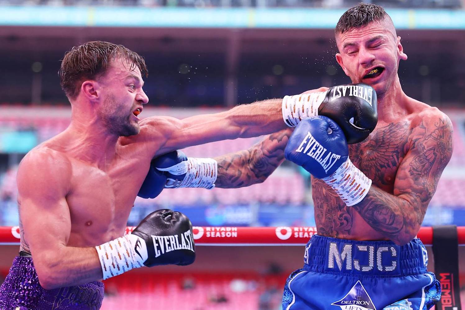 LONDON, ENGLAND - SEPTEMBER 21: Josh Padley punches Mark Chamberlain during the Lightweight fight between Mark Chamberlain and Josh Padley, on the Riyadh Season - Wembley Edition card at Wembley Stadium on September 21, 2024 in London, England. (Photo by Richard Pelham/Getty Images)