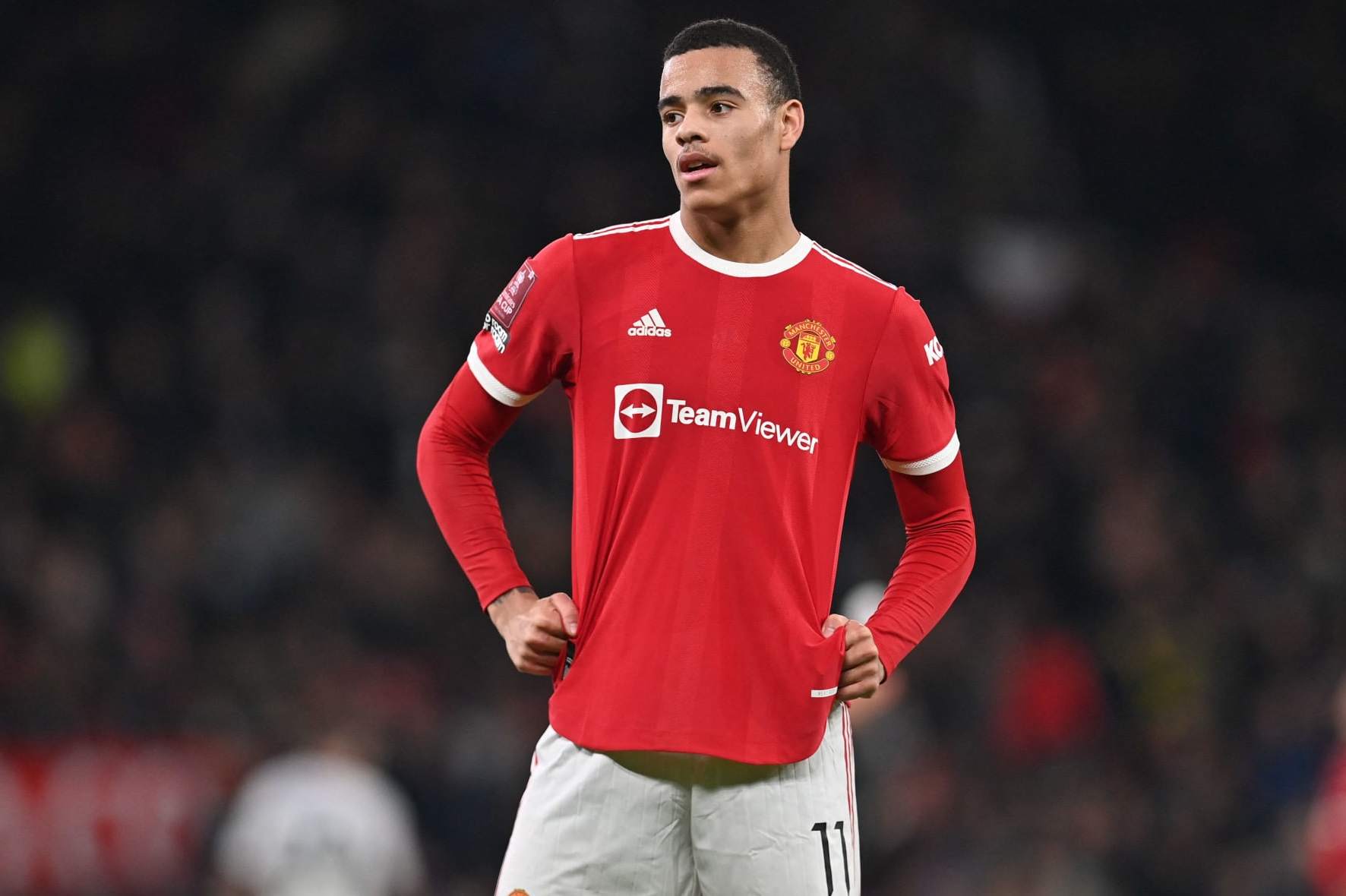 Manchester United's English striker Mason Greenwood geatures during the English FA Cup third round football match between Manchester United and Aston Villa at Old Trafford in Manchester, north-west England, on January 10, 2022. - RESTRICTED TO EDITORIAL USE. No use with unauthorized audio, video, data, fixture lists, club/league logos or 'live' services. Online in-match use limited to 120 images. An additional 40 images may be used in extra time. No video emulation. Social media in-match use limited to 120 images. An additional 40 images may be used in extra time. No use in betting publications, games or single club/league/player publications. (Photo by Paul ELLIS / AFP) / RESTRICTED TO EDITORIAL USE. No use with unauthorized audio, video, data, fixture lists, club/league logos or 'live' services. Online in-match use limited to 120 images. An additional 40 images may be used in extra time. No video emulation. Social media in-match use limited to 120 images. An additional 40 images may be used in extra time. No use in betting publications, games or single club/league/player publications. / RESTRICTED TO EDITORIAL USE. No use with unauthorized audio, video, data, fixture lists, club/league logos or 'live' services. Online in-match use limited to 120 images. An additional 40 images may be used in extra time. No video emulation. Social media in-match use limited to 120 images. An additional 40 images may be used in extra time. No use in betting publications, games or single club/league/player publications. (Photo by PAUL ELLIS/AFP via Getty Images)