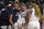 Connecticut's Paige Bueckers (5) is helped off the court by Amari DeBerrym, left, after injuring herself in the second half of an NCAA college basketball game against Notre Dame, Sunday, Dec. 5, 2021, in Storrs, Conn. (AP Photo/Jessica Hill)