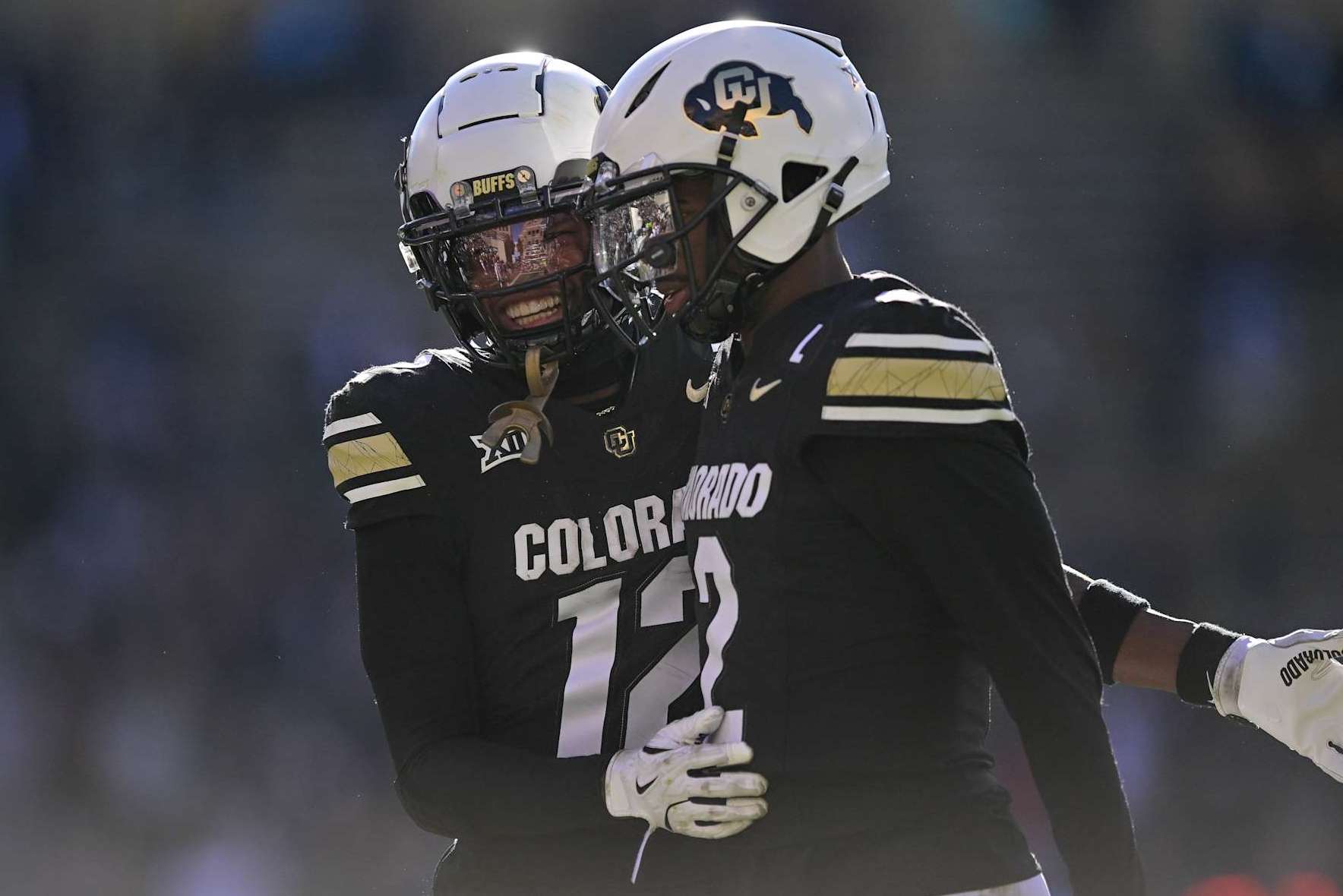 BOULDER, CO - NOVEMBER 29: Shedeur Sanders #2 and Travis Hunter #12 of the Colorado Buffaloes celebrate after a third quarter touchdown against the Oklahoma State Cowboys at Folsom Field on November 29, 2024 in Boulder, Colorado. (Photo by Dustin Bradford/Getty Images)