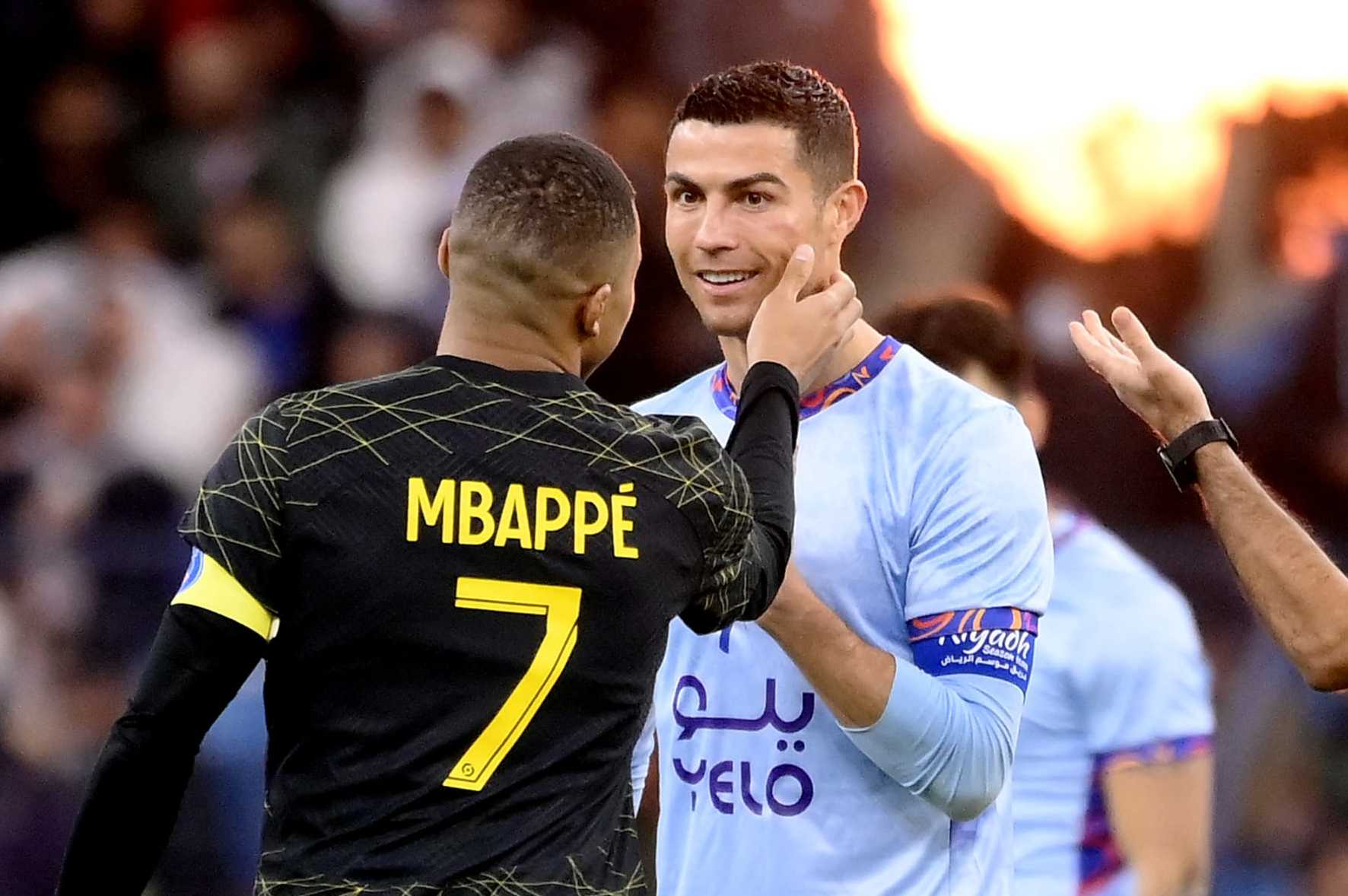 Paris Saint-Germain's French forward Kylian Mbappe (L) chats with Riyadh All-Star's Portuguese forward Cristiano Ronaldo (R) during the Riyadh Season Cup football match between the Riyadh All-Stars and Paris Saint-Germain at the King Fahd Stadium in Riyadh on January 19, 2023. (Photo by FRANCK FIFE / AFP) (Photo by FRANCK FIFE/AFP via Getty Images)