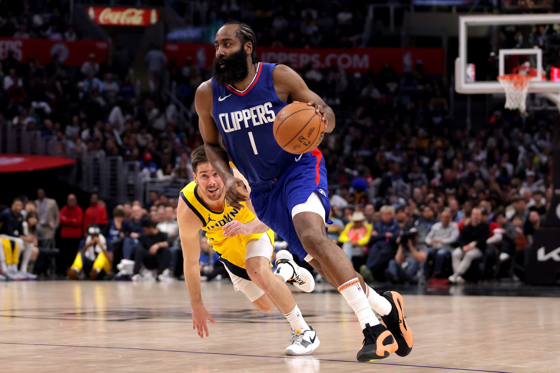 LOS ANGELES, CALIFORNIA - MARCH 25: James Harden #1 of the Los Angeles Clippers drives past T.J. McConnell #9 of the Indiana Pacers during the fourth quarter at Crypto.com Arena on March 25, 2024 in Los Angeles, California. NOTE TO USER: User expressly acknowledges and agrees that, by downloading and or using this photograph, User is consenting to the terms and conditions of the Getty Images License Agreement. (Photo by Katelyn Mulcahy/Getty Images)