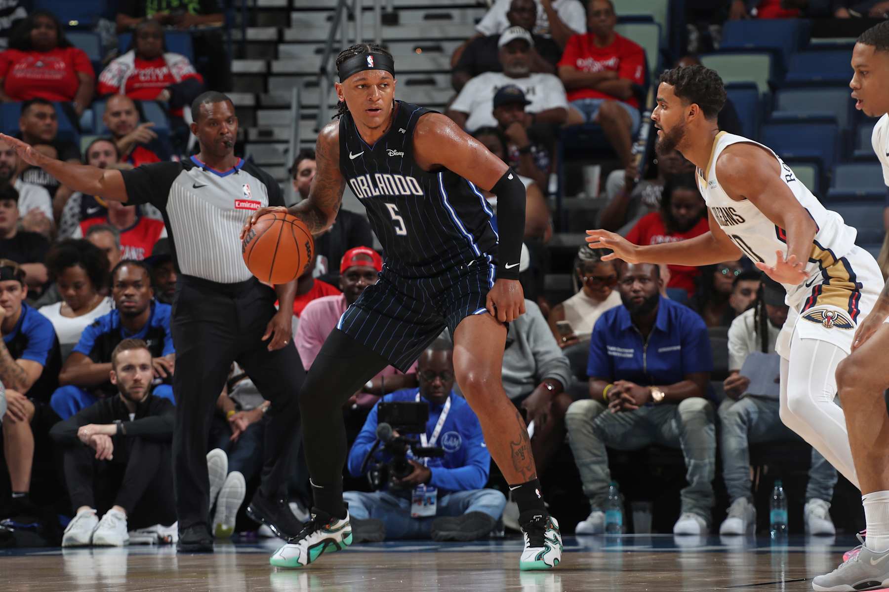 NEW ORLEANS, LA - OCTOBER 7: Paolo Banchero #5 of the Orlando Magic drives to the basket during the game against the New Orleans Pelicans on October 7, 2024 at the Smoothie King Center in New Orleans, Louisiana. NOTE TO USER: User expressly acknowledges and agrees that, by downloading and or using this Photograph, user is consenting to the terms and conditions of the Getty Images License Agreement. Mandatory Copyright Notice: Copyright 2024 NBAE (Photo by Layne Murdoch Jr./NBAE via Getty Images)