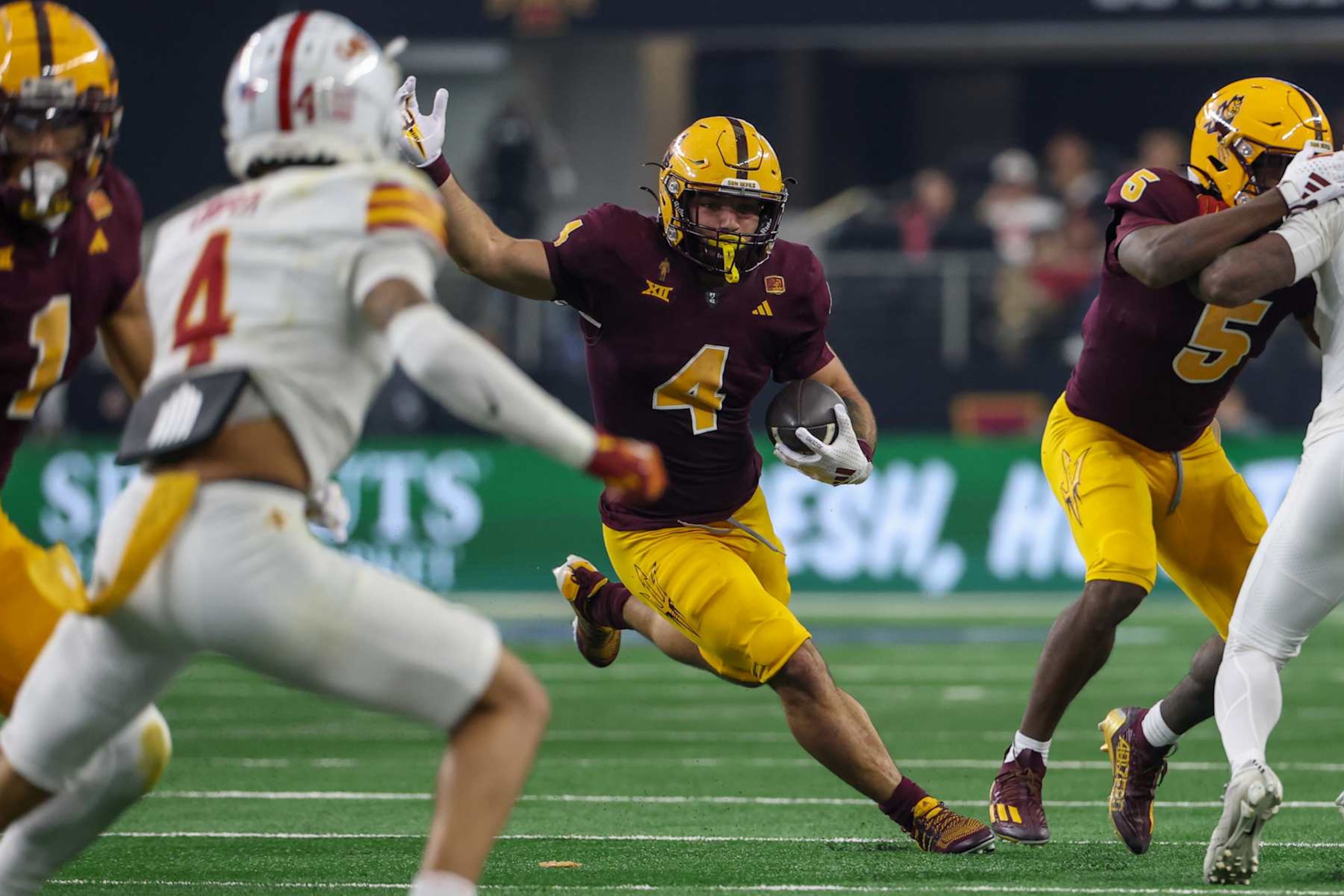 ARLINGTON, TX - DECEMBER 07: Arizona State Sun Devils running back Cam Skattebo (4) runs for a touchdown during the Big 12 Championship game between the Arizona State Sun Devils and the Iowa State Cyclones on December 7, 2024, at AT&T Stadium in Arlington, Texas. (Photo by David Buono/Icon Sportswire via Getty Images)