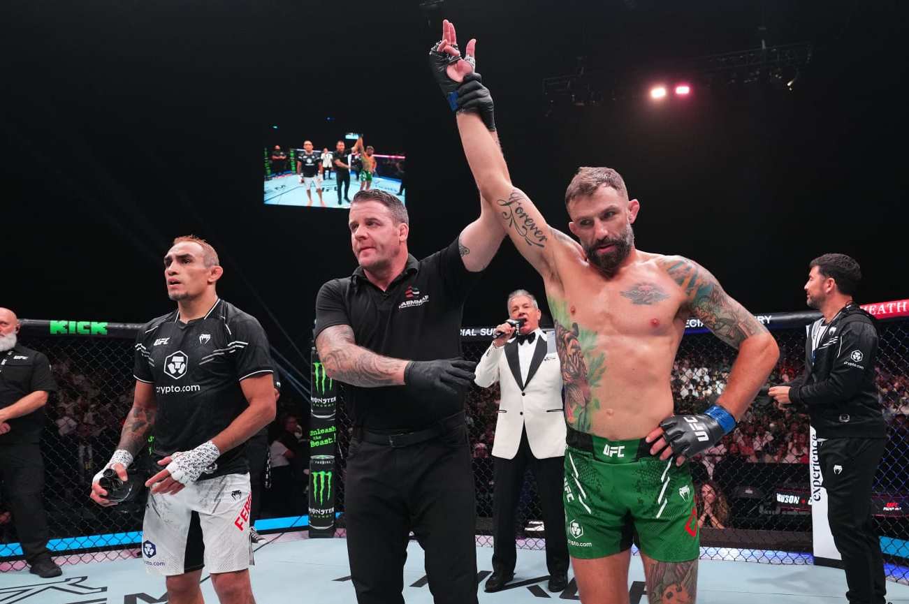 ABU DHABI, UNITED ARAB EMIRATES - AUGUST 03: (R-L) Michael Chiesa reacts after defeating Tony Ferguson in a welterweight fight during the UFC Fight Night event at Etihad Arena on August 03, 2024 in Abu Dhabi, United Arab Emirates. (Photo by Josh Hedges/Zuffa LLC via Getty Images)
