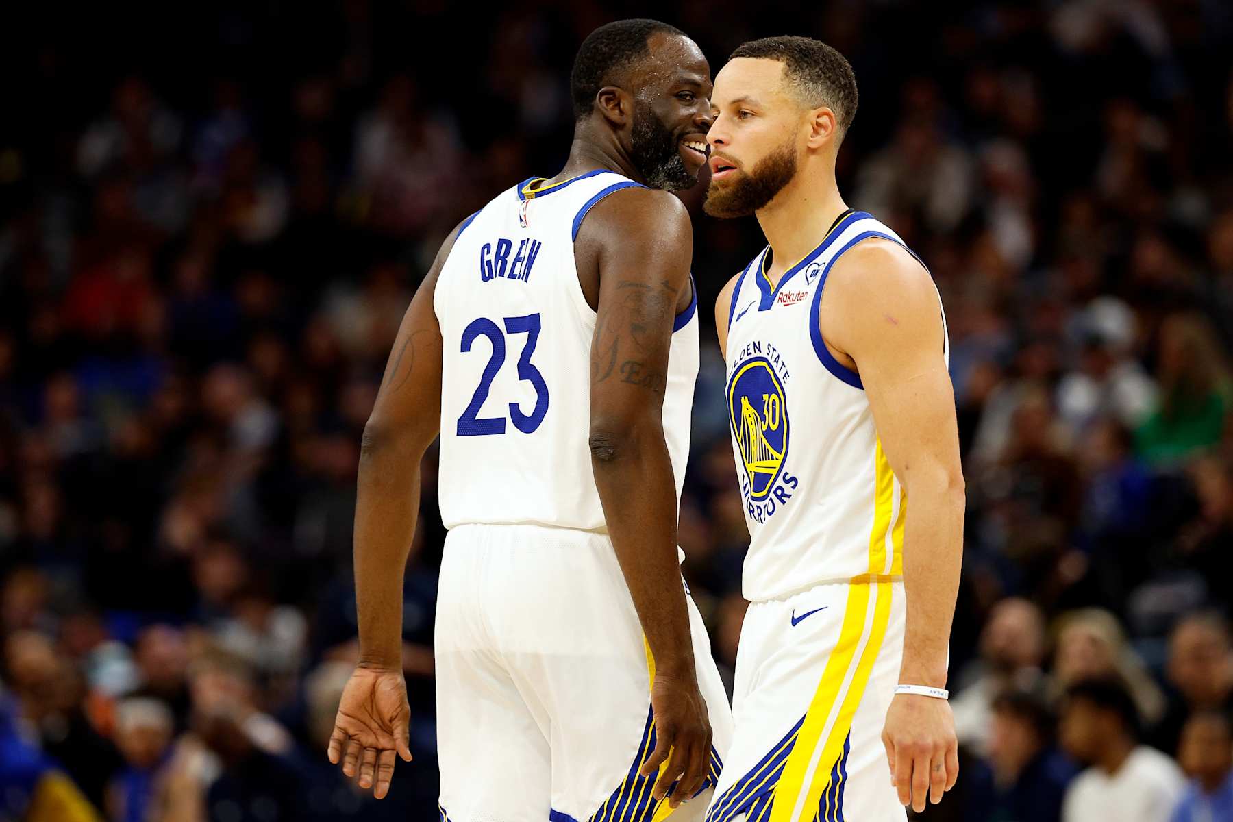 MINNEAPOLIS, MINNESOTA - MARCH 24: Draymond Green #23 of the Golden State Warriors and Stephen Curry #30 look on against the Minnesota Timberwolves in the second quarter at Target Center on March 24, 2024 in Minneapolis, Minnesota. The Timberwolves defeated the Warriors 114-110. NOTE TO USER: User expressly acknowledges and agrees that, by downloading and or using this photograph, User is consenting to the terms and conditions of the Getty Images License Agreement. (Photo by David Berding/Getty Images)