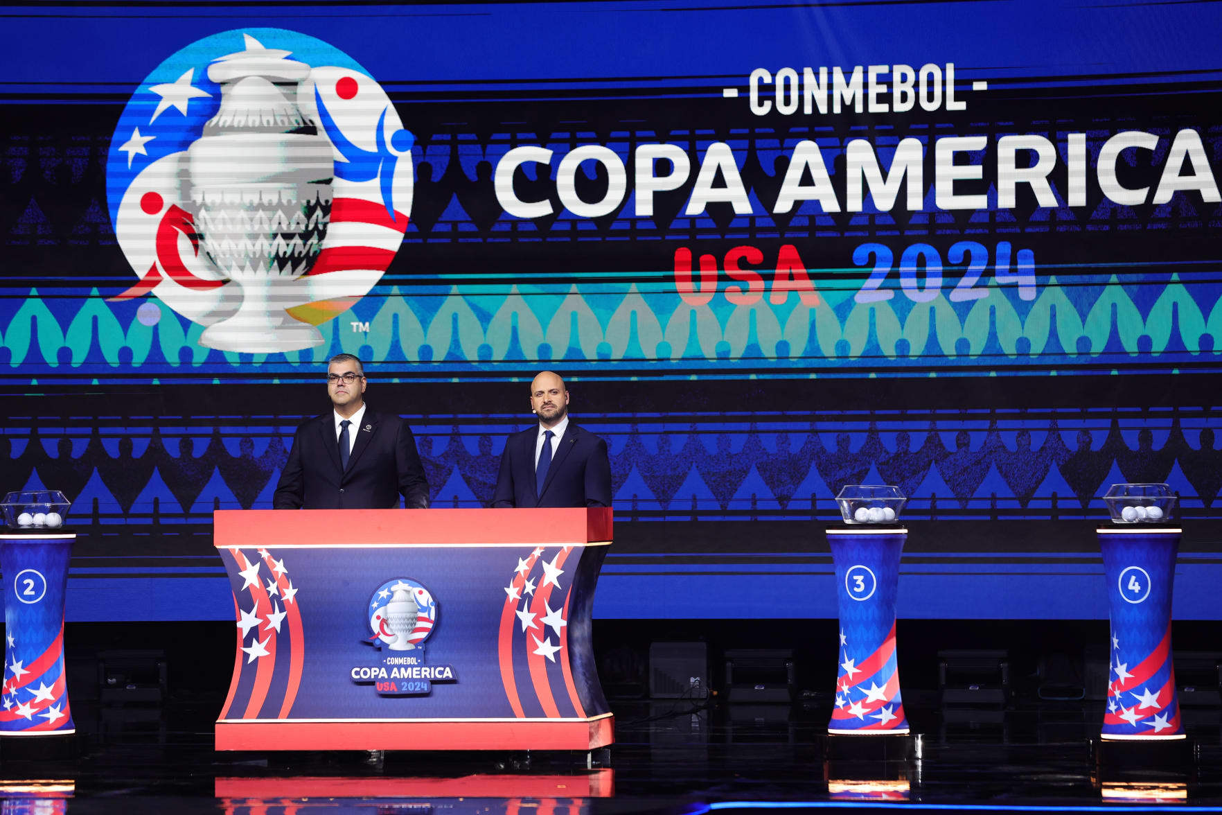 MIAMI, FLORIDA - DECEMBER 07: (L-R) Fred Nantes, Director of Competitions of CONMEBOL, and Carlos Fernandez Chief Football Competitions of CONCACAF speak during the official draw of CONMEBOL Copa America 2024 at James L. Knight Center on December 07, 2023 in Miami, Florida. (Photo by Megan Briggs/Getty Images)