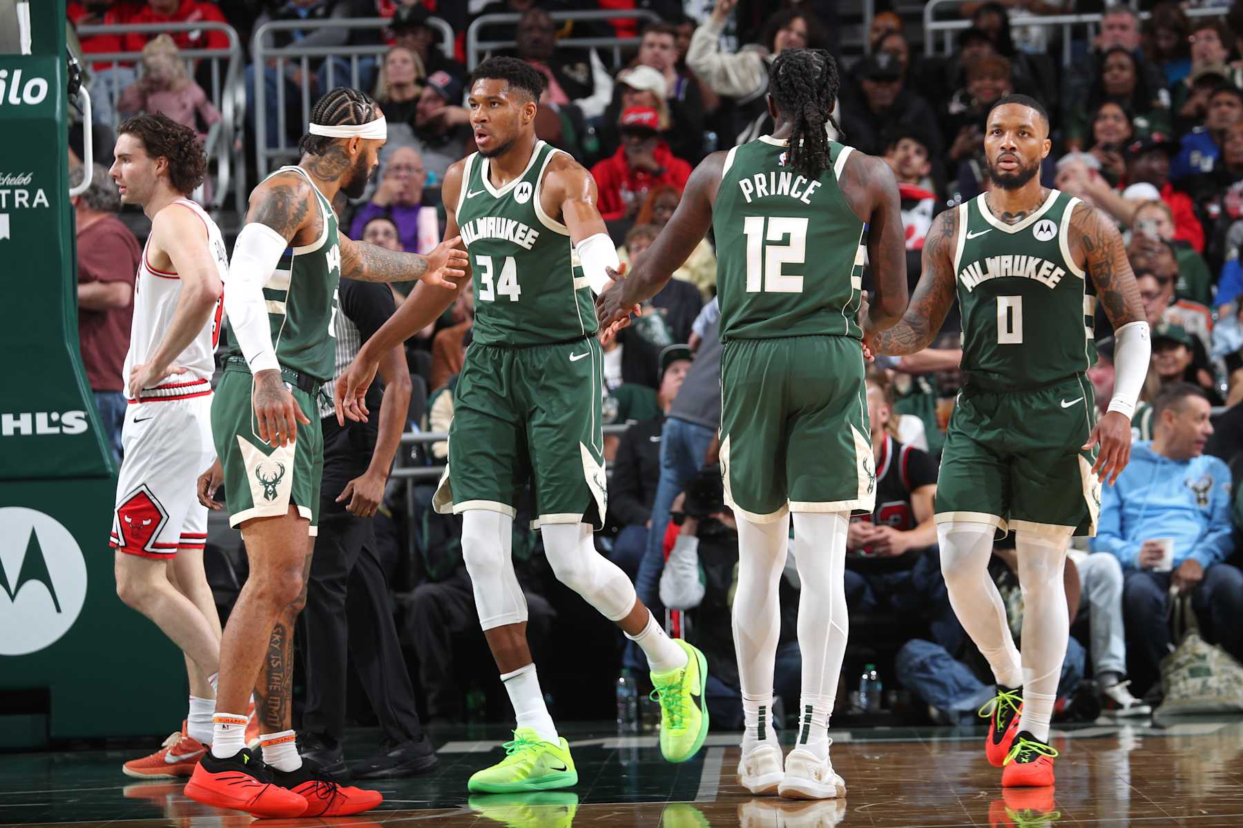 MILWAUKEE, WI - OCTOBER 25: Giannis Antetokounmpo #34 and Damian Lillard #0 of the Milwaukee Bucks high five Taurean Prince #12 during the game against the Chicago Bulls on October 25, 2024 at the Fiserv Forum Center in Milwaukee, Wisconsin. NOTE TO USER: User expressly acknowledges and agrees that, by downloading and or using this Photograph, user is consenting to the terms and conditions of the Getty Images License Agreement. Mandatory Copyright Notice: Copyright 2024 NBAE (Photo by Gary Dineen/NBAE via Getty Images).