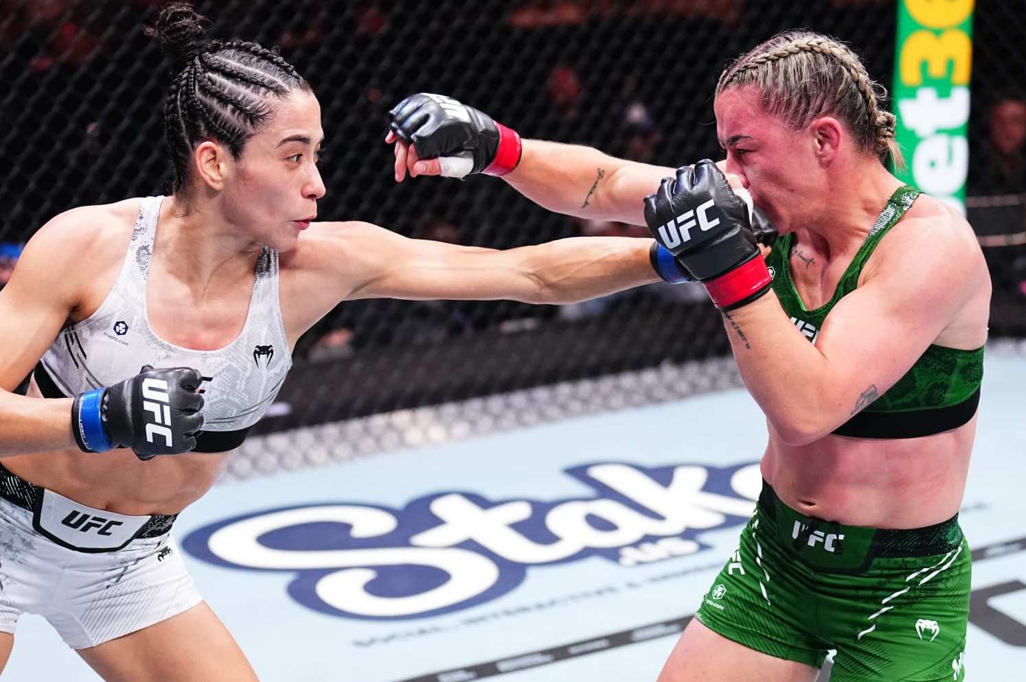MANCHESTER, ENGLAND - JULY 27: (L-R) Bruna Brasil of Brazil punches Molly McCann of England in a strawweight bout during the UFC 304 event at Co-op Live on July 27, 2024 in Manchester, England. (Photo by Chris Unger/Zuffa LLC via Getty Images)