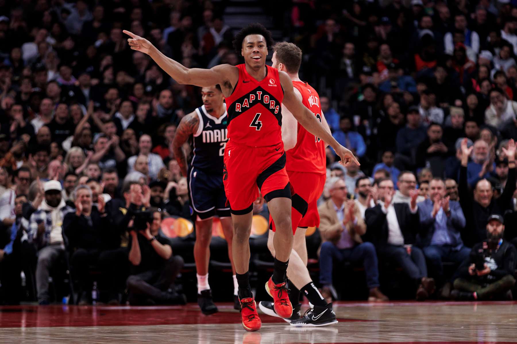 TORONTO, CANADA - FEBRUARY 28: Scottie Barnes #4 of the Toronto Raptors reacts against the Dallas Mavericks  in the first half of their NBA game at Scotiabank Arena on February 28, 2024 in Toronto, Canada. NOTE TO USER: User expressly acknowledges and agrees that, by downloading and or using this photograph, User is consenting to the terms and conditions of the Getty Images License Agreement. (Photo by Cole Burston/Getty Images)