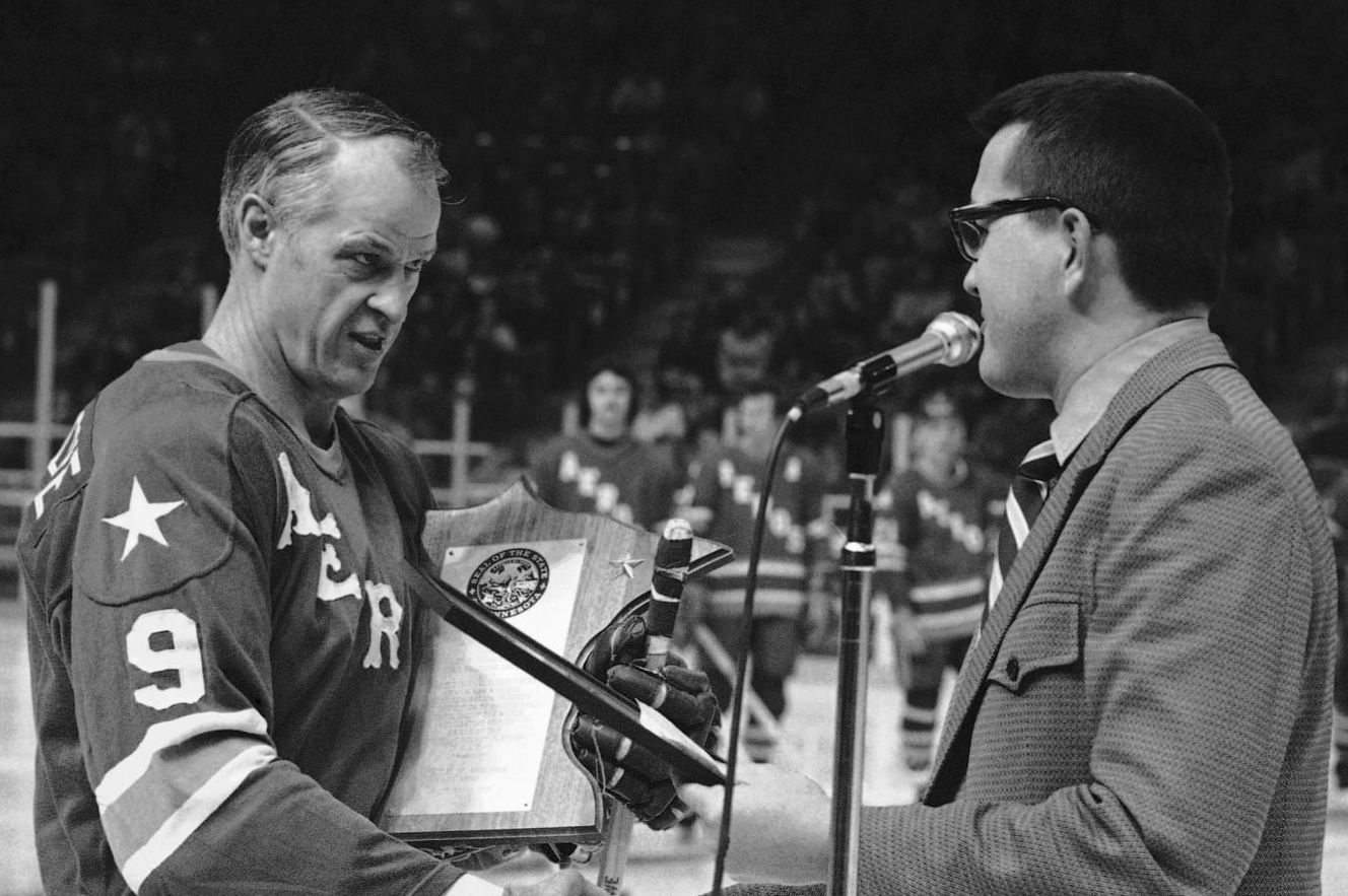 Gordie Howe of the Houston Aeros is presented a plaque prior on Wednesday, Feb. 12, 1975 in St. Paul, Minnesota, WHA game with the Minnesota Fighting Saints by State Rep. John Lindstrom. Gov. Wendell Anderson proclaimed Wednesday as “Gordie Howe Day”, and Lindstrom presented the plaques in the Governor’s absence. (AP Photo)