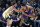 Golden State Warriors guard Stephen Curry and Phoenix Suns guard Devin Booker (1) face off during the first half of an NBA basketball game, Tuesday, Oct. 25, 2022, in Phoenix. (AP Photo/Rick Scuteri)