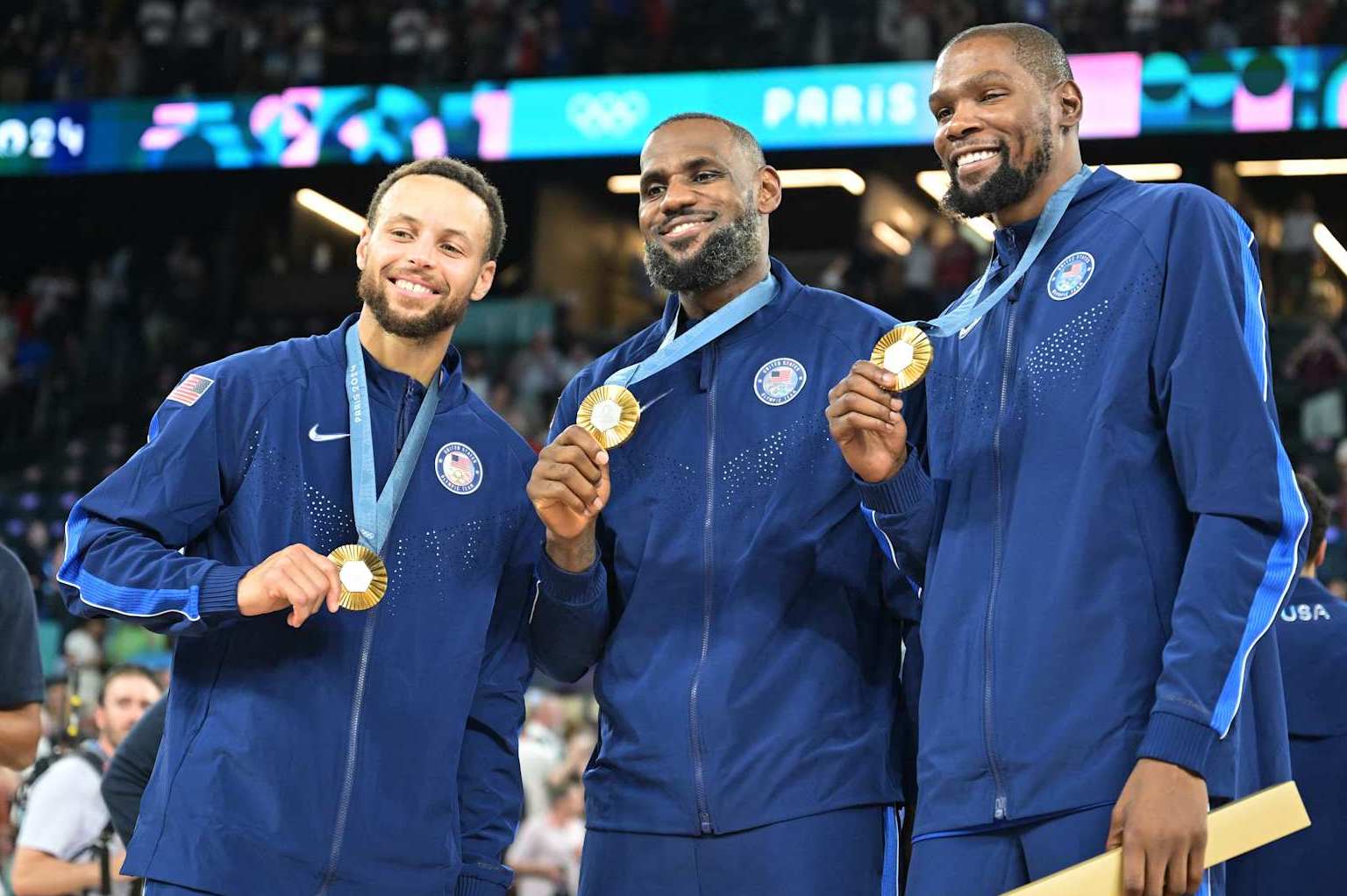 Gold medallists (From L) USA's #04 Stephen Curry, USA's #06 LeBron James and USA's #07 Kevin Durant pose after the men's Gold Medal basketball match between France and USA during the Paris 2024 Olympic Games at the Bercy  Arena in Paris on August 10, 2024. (Photo by Damien MEYER / AFP) (Photo by DAMIEN MEYER/AFP via Getty Images)