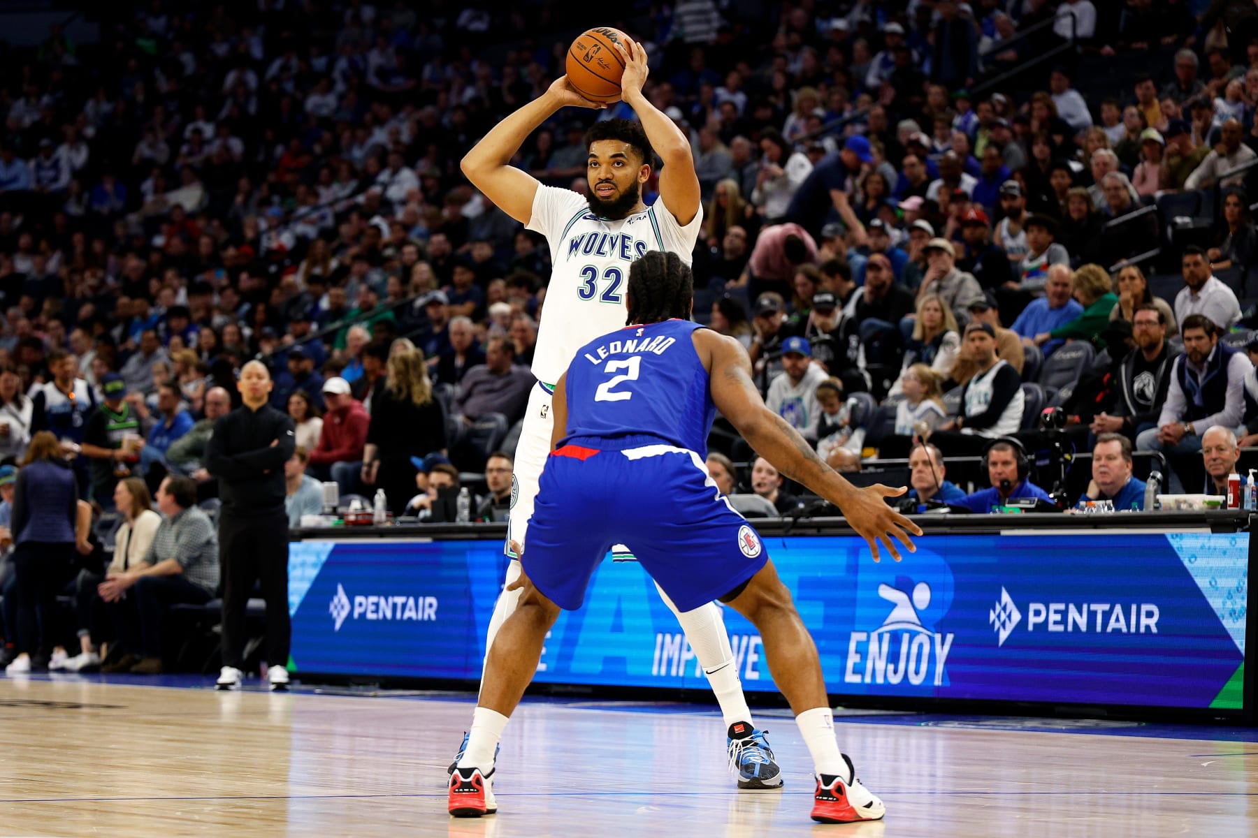 MINNEAPOLIS, MINNESOTA - MARCH 03: Karl-Anthony Towns #32 of the Minnesota Timberwolves looks to pass against Kawhi Leonard #2 of the LA Clippers in the third quarter at Target Center on March 03, 2024 in Minneapolis, Minnesota. The Clippers defeated the Timberwolves 89-88. NOTE TO USER: User expressly acknowledges and agrees that, by downloading and or using this photograph, User is consenting to the terms and conditions of the Getty Images License Agreement. (Photo by David Berding/Getty Images)