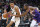 San Antonio Spurs center Victor Wembanyama (1) drives on Phoenix Suns forward Kevin Durant during the second half of an NBA basketball game Thursday, Nov 2, 2023, in Phoenix. (AP Photo/Rick Scuteri)