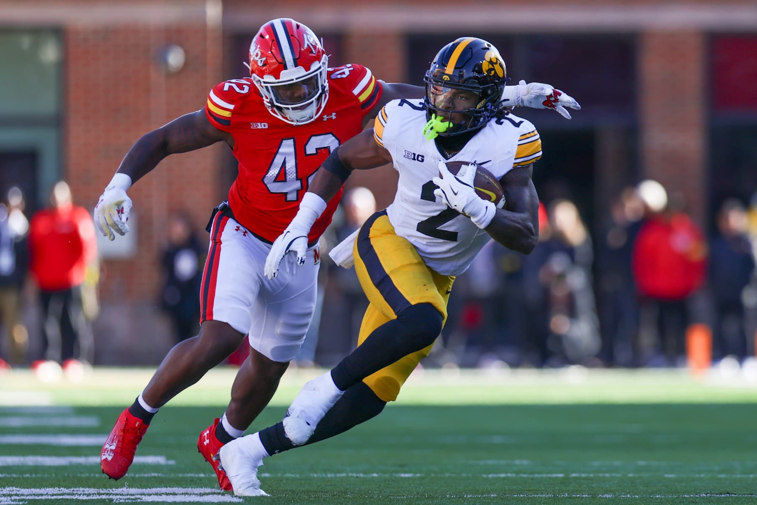COLLEGE PARK, MD - NOVEMBER 23: Kaleb Johnson #2 of the Iowa Hawkeyes rushes the ball as DJ Samuels #42 of the Maryland Terrapins attempts to tackle during a game between Iowa Hawkeyes and Maryland Terrapins at SECU Stadium on November 23, 2024 in College Park, Maryland. (Photo by Roger Wimmer/ISI Photos/Getty Images)