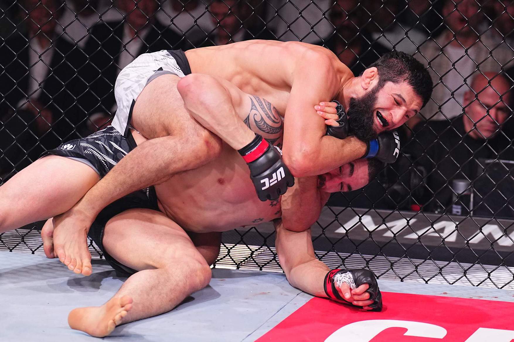 ABU DHABI, UNITED ARAB EMIRATES - OCTOBER 26: (L-R) Khamzat Chimaev of Russia secures a submission against Robert Whittaker of New Zealand in a middleweight fight during the UFC 308 event at Etihad Arena on October 26, 2024 in Abu Dhabi, United Arab Emirates. (Photo by Chris Unger/Zuffa LLC)