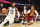 CLEVELAND, OHIO - DECEMBER 05: Donovan Mitchell #45 of the Utah Jazz drives to the basket around Darius Garland #10 of the Cleveland Cavaliers during the third quarter at Rocket Mortgage Fieldhouse on December 05, 2021 in Cleveland, Ohio. The Jazz defeated the Cavaliers 109-108. NOTE TO USER: User expressly acknowledges and agrees that, by downloading and/or using this photograph, user is consenting to the terms and conditions of the Getty Images License Agreement. (Photo by Jason Miller/Getty Images)