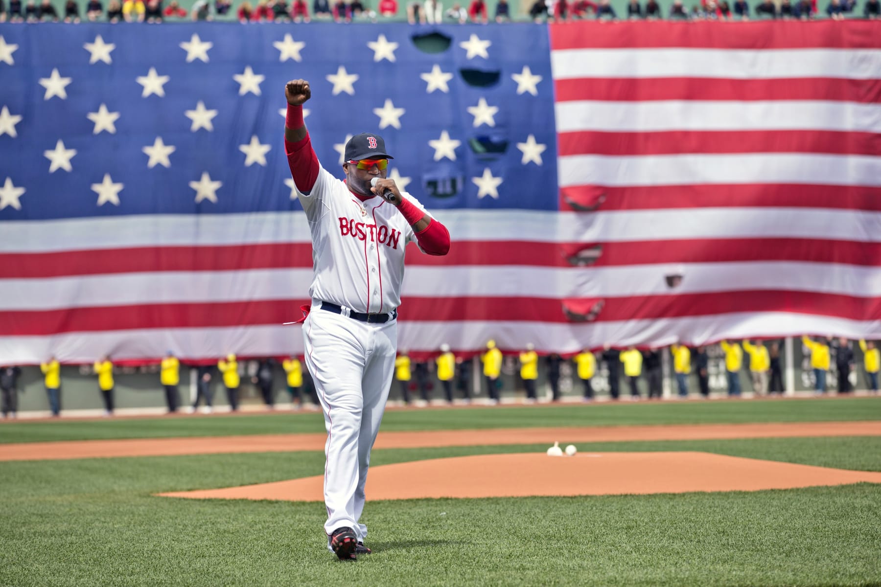 Baseball: Boston Red Sox David Ortiz (34) addressing the crowd on field before game vs Kansas City Royals at Fenway Park. A ceremony was held before the game in remembrance of the victims of the 4/15/13 Boston Marathon Bombings. View of American flag draped over Green Monster.
Boston, MA 4/20/2013
CREDIT: Damian Strohmeyer (Photo by Damian Strohmeyer /Sports Illustrated via Getty Images)
(Set Number: X156411 TK1 R4 F146 )