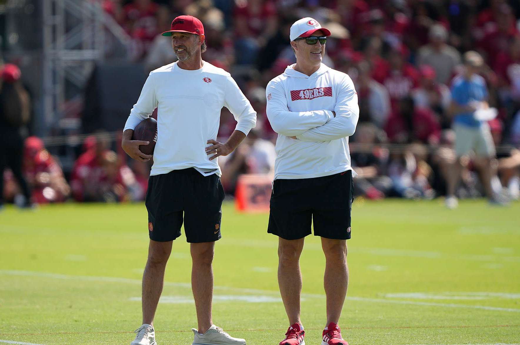 SANTA CLARA, CALIFORNIA - JULY 29: Head coach Kyle Shanahan (L) and General manager John Lynch (R) of the San Francisco 49ers looks on during training camp at SAP Performance Facility on July 29, 2024 in Santa Clara, California. (Photo by Thearon W. Henderson/Getty Images)