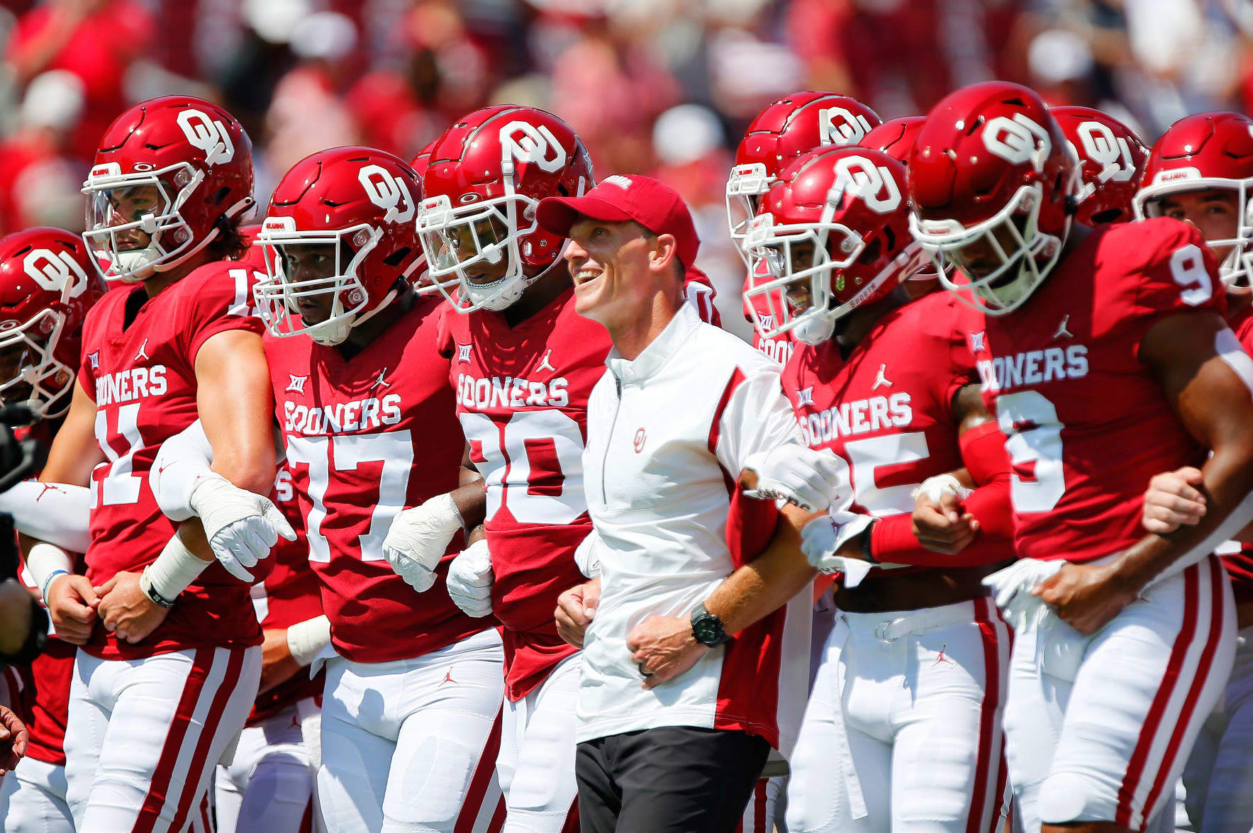NORMAN, OK - SEPTEMBER 3: Head coach Brent Venables of the Oklahoma Sooners walks arm in arm with his team before a game against the UTEP Miners at Gaylord Family Oklahoma Memorial Stadium on September 3, 2022 in Norman, Oklahoma. (Photo by Brian Bahr/Getty Images)