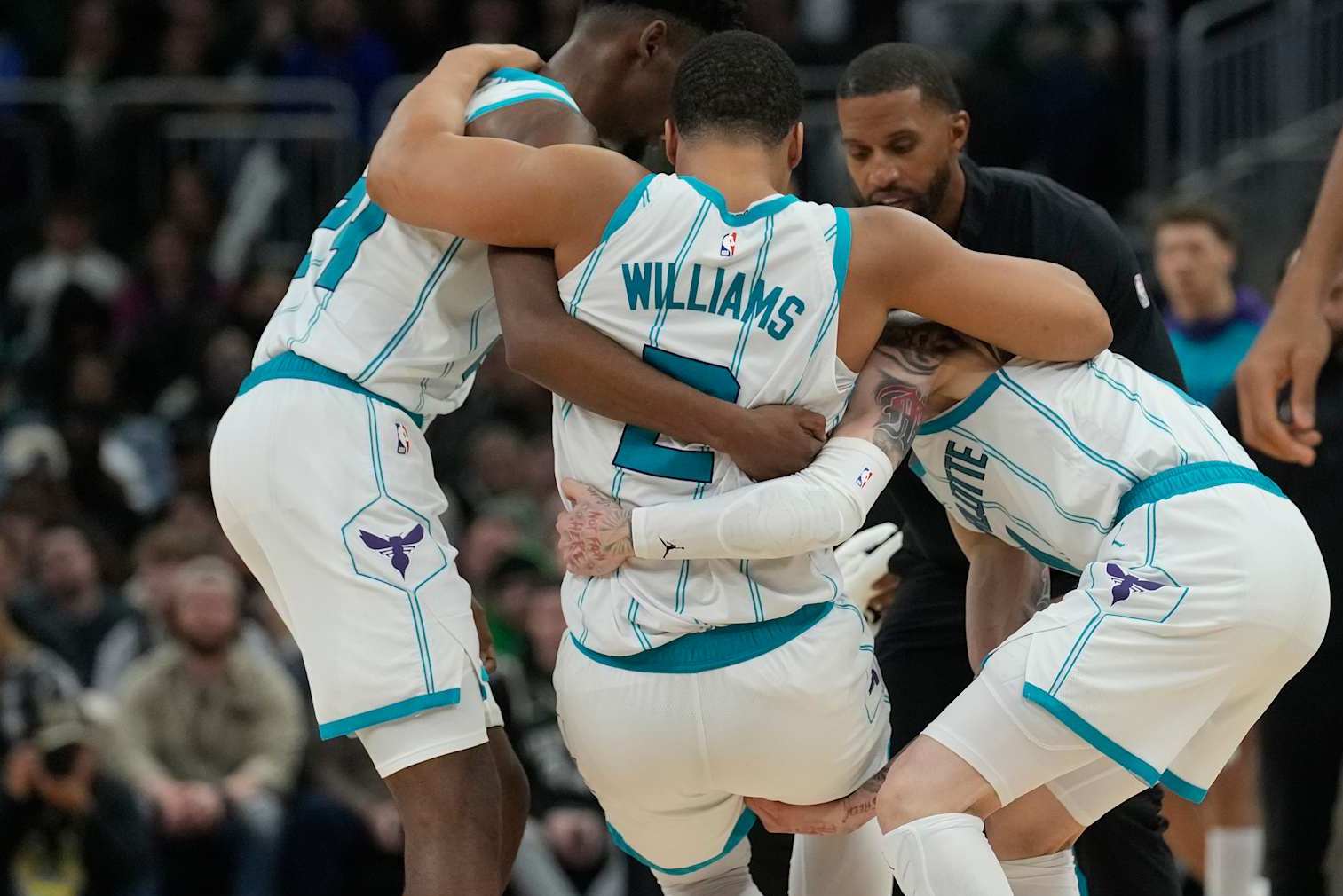 MILWAUKEE, WISCONSIN - NOVEMBER 23: Grant Williams #2 of the Charlotte Hornets helped by his teammates after being injured during the fourth quarter of a game against the Milwaukee Bucks at Fiserv Forum on November 23, 2024 in Milwaukee, Wisconsin. NOTE TO USER: User expressly acknowledges and agrees that, by downloading and or using this photograph, User is consenting to the terms and conditions of the Getty Images License Agreement. (Photo by Patrick McDermott/Getty Images)