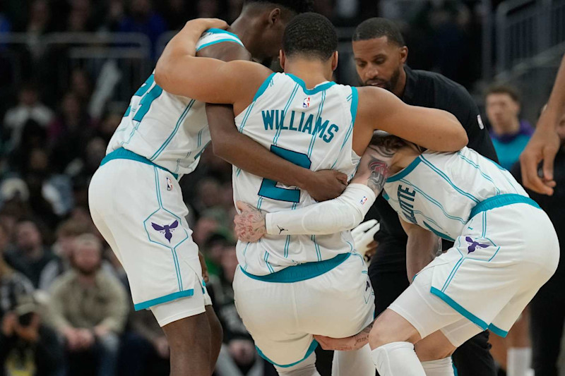 MILWAUKEE, WISCONSIN - NOVEMBER 23: Grant Williams #2 of the Charlotte Hornets helped by his teammates after being injured during the fourth quarter of a game against the Milwaukee Bucks at Fiserv Forum on November 23, 2024 in Milwaukee, Wisconsin. NOTE TO USER: User expressly acknowledges and agrees that, by downloading and or using this photograph, User is consenting to the terms and conditions of the Getty Images License Agreement. (Photo by Patrick McDermott/Getty Images)