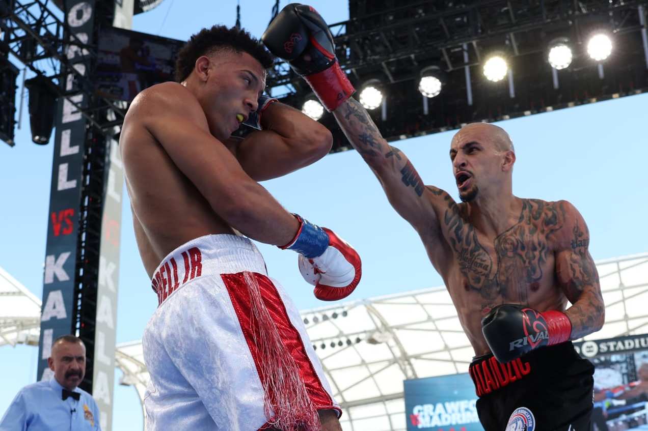 LOS ANGELES, CALIFORNIA - AUGUST 3: David Morrell (white with red shorts) and Radivoje Kalajdzic (black shorts) during their WBA World Super Lightweight Title Contest at BMO Stadium on August 3, 2024 in Los Angeles, California. (Photo by Mark Robinson/Matchroom Boxing/Getty Images)