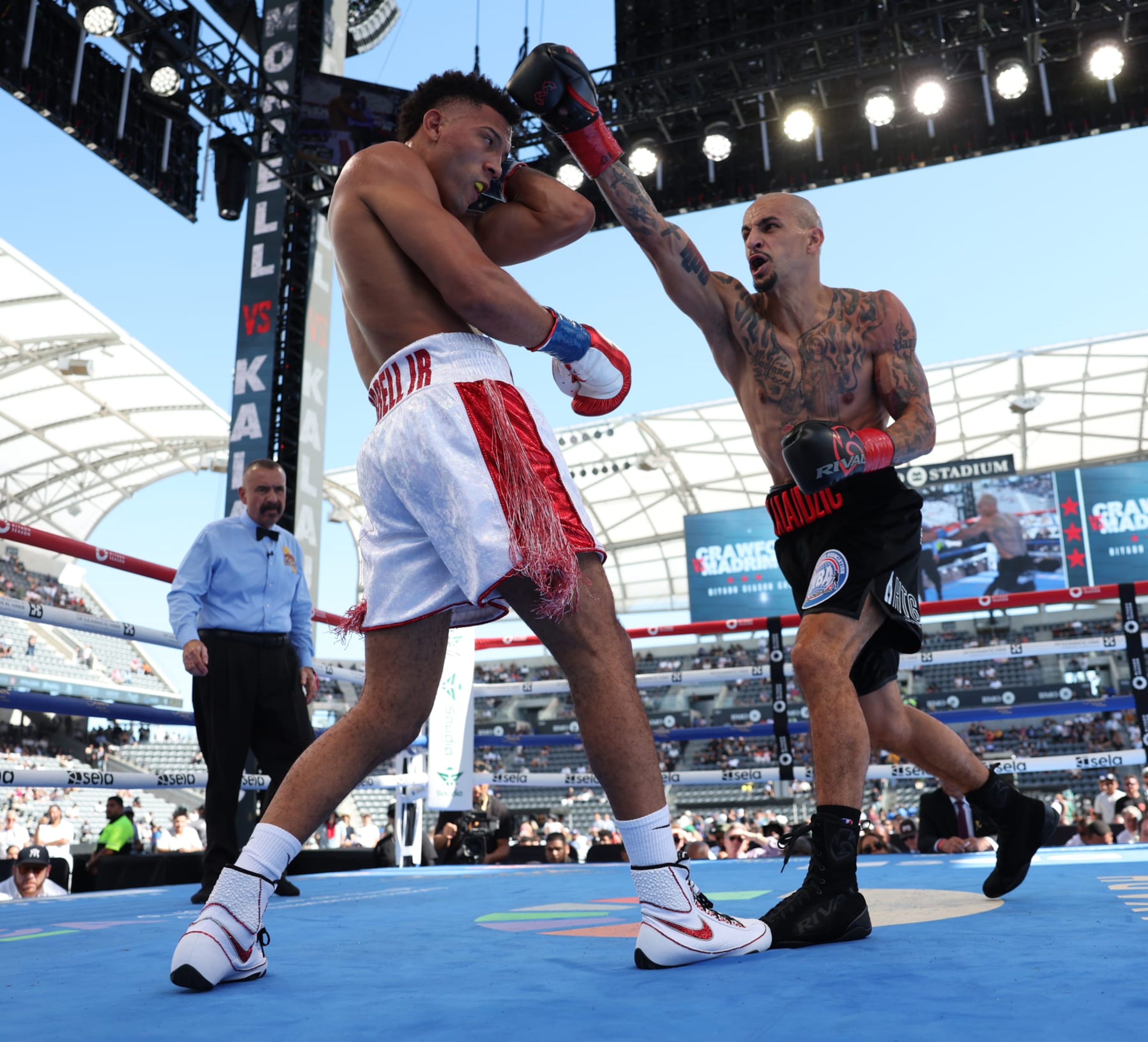 LOS ANGELES, CALIFORNIA - AUGUST 3: David Morrell (white with red shorts) and Radivoje Kalajdzic (black shorts) during their WBA World Super Lightweight Title Contest  at BMO Stadium on August 3, 2024 in Los Angeles, California.  (Photo by Mark Robinson/Matchroom Boxing/Getty Images)