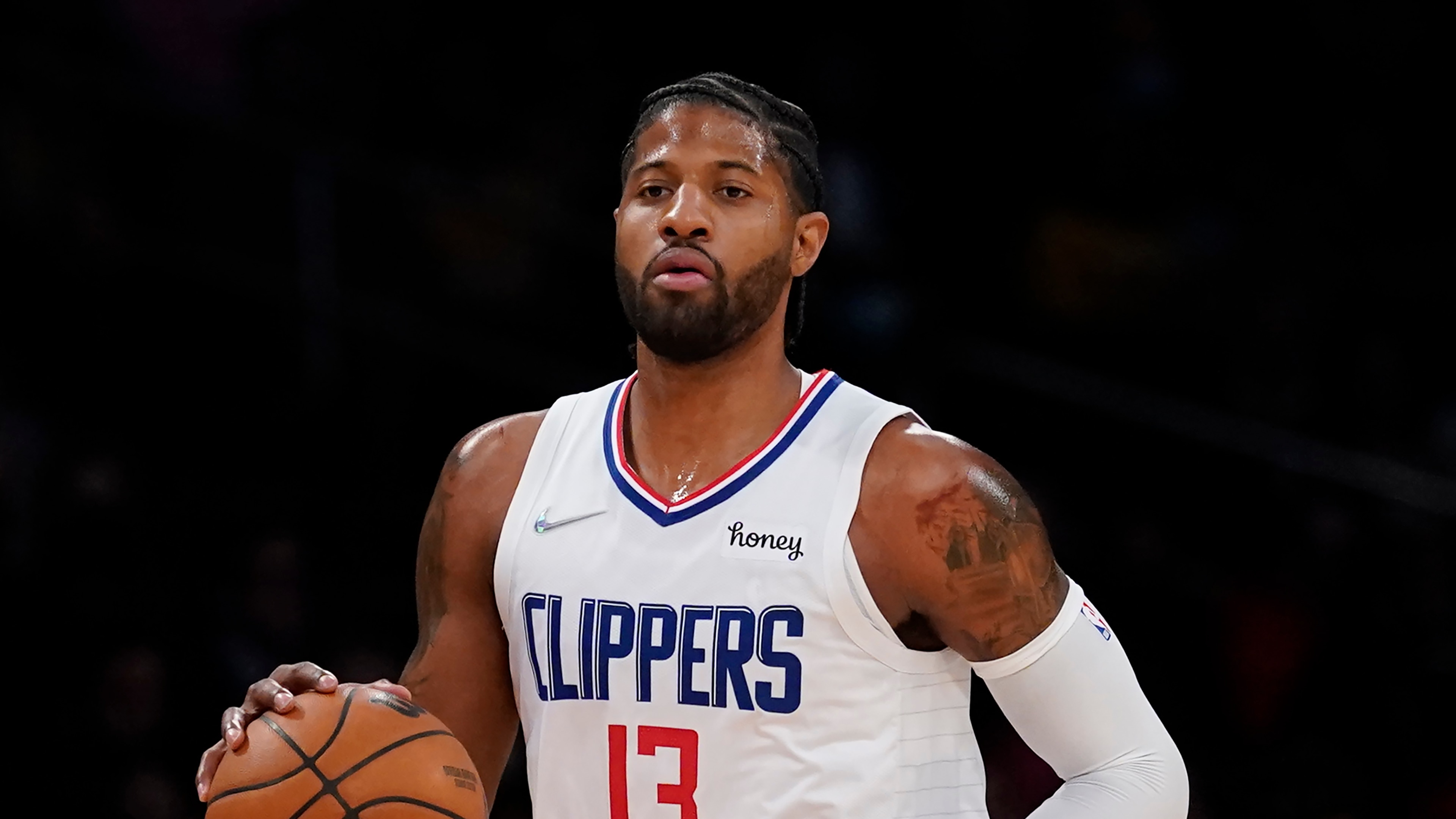Los Angeles Clippers guard Paul George (13) controls the ball during an NBA basketball game against the Los Angeles Lakers in Los Angeles, Friday, Dec. 3, 2021. (AP Photo/Ashley Landis)