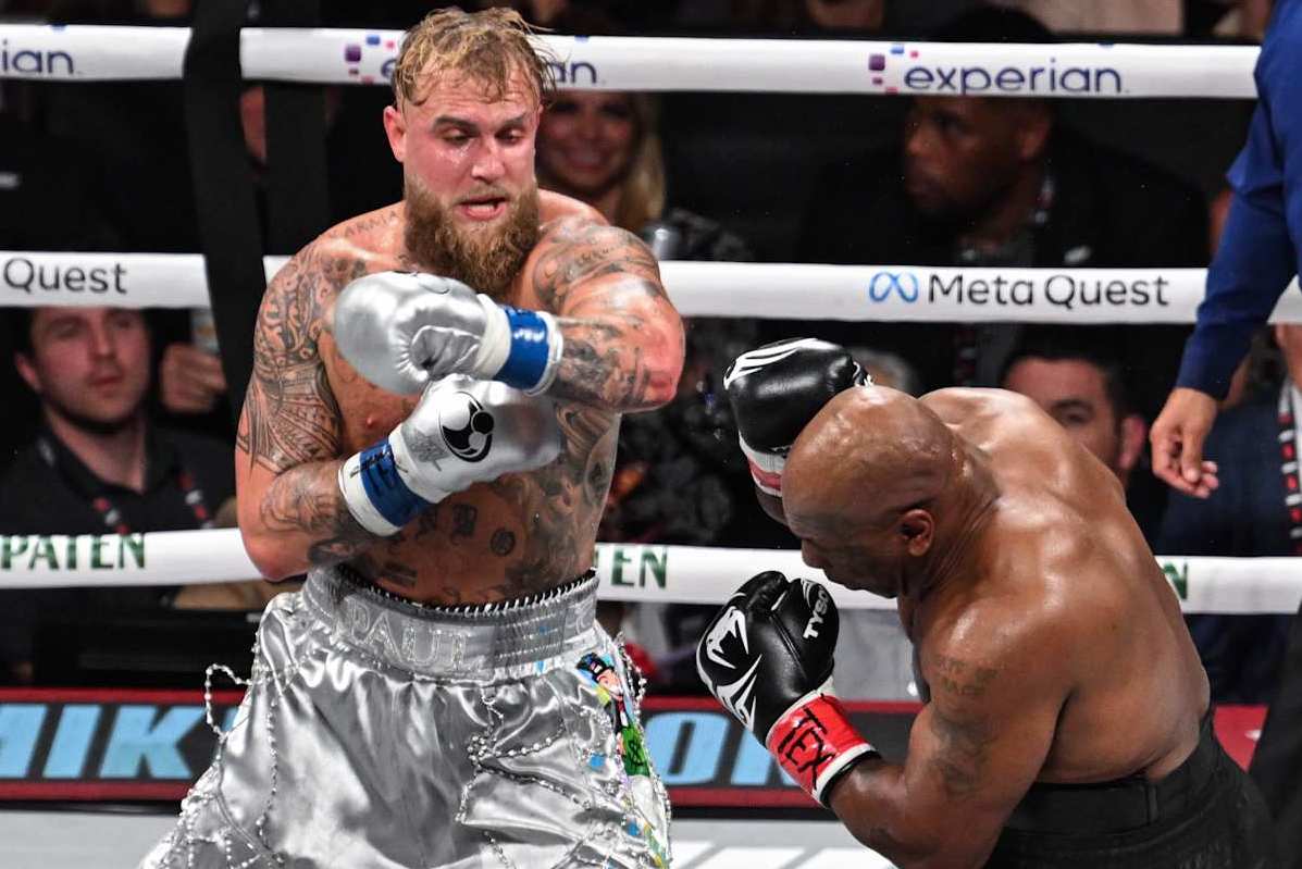 ARLINGTON, TEXAS - NOVEMBER 15: Mike Tyson (in black short) and Jake Paul (in silver short) exchange punches during their heavyweight world titles of the Premiere Boxing Championship on Friday night at AT&T Stadium in Arlington, Texas, United States on November 15, 2024. (Photo by Tayfun Coskun/Anadolu via Getty Images)