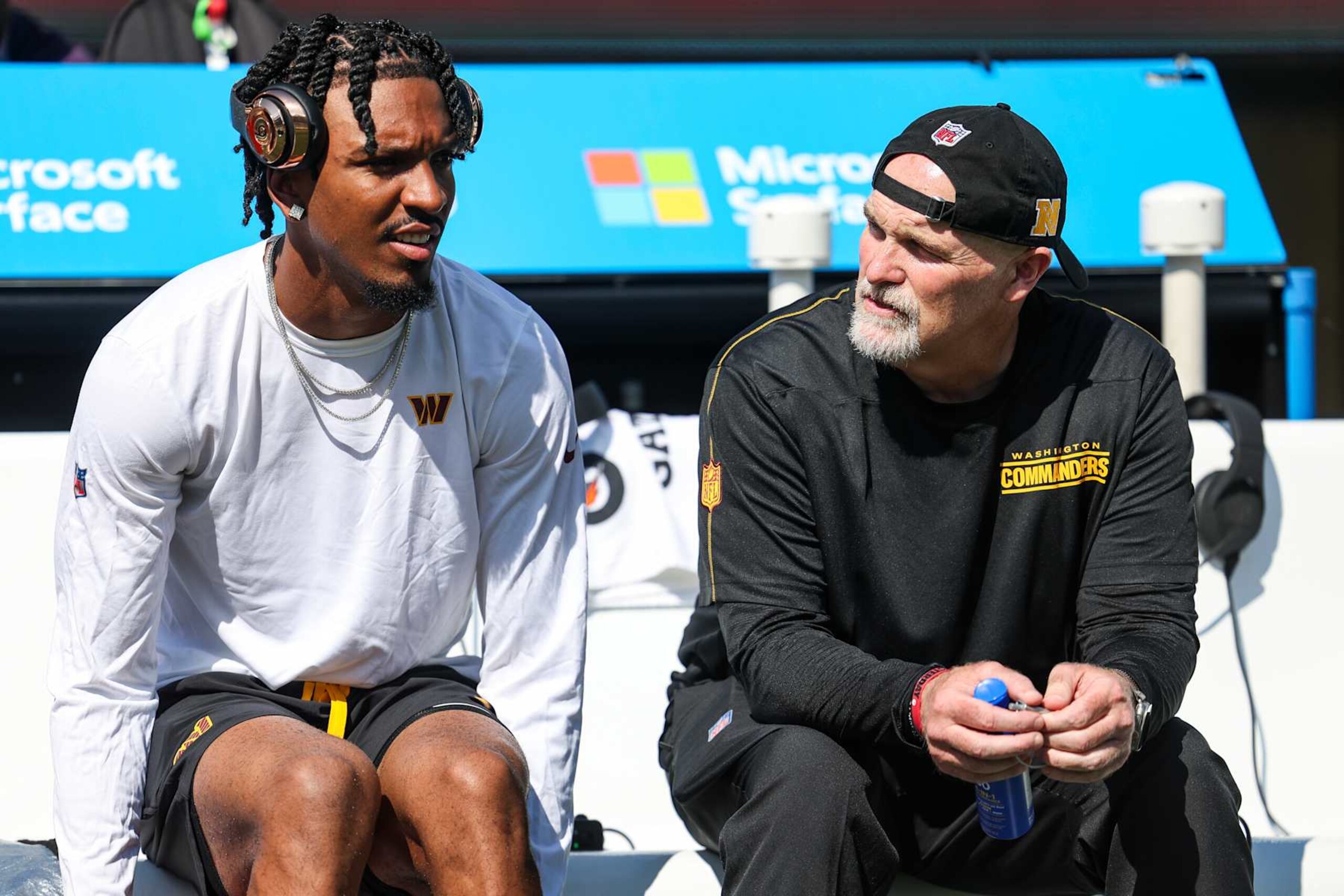 EAST RUTHERFORD, NJ - AUGUST 10: Jayden Daniels #5 of the Washington Commanders talks with head coach Dan Quinn prior to an NFL football game against the New York Jets at MetLife Stadium on August 10, 2024 in East Rutherford, NJ. (Photo by Perry Knotts/Getty Images)