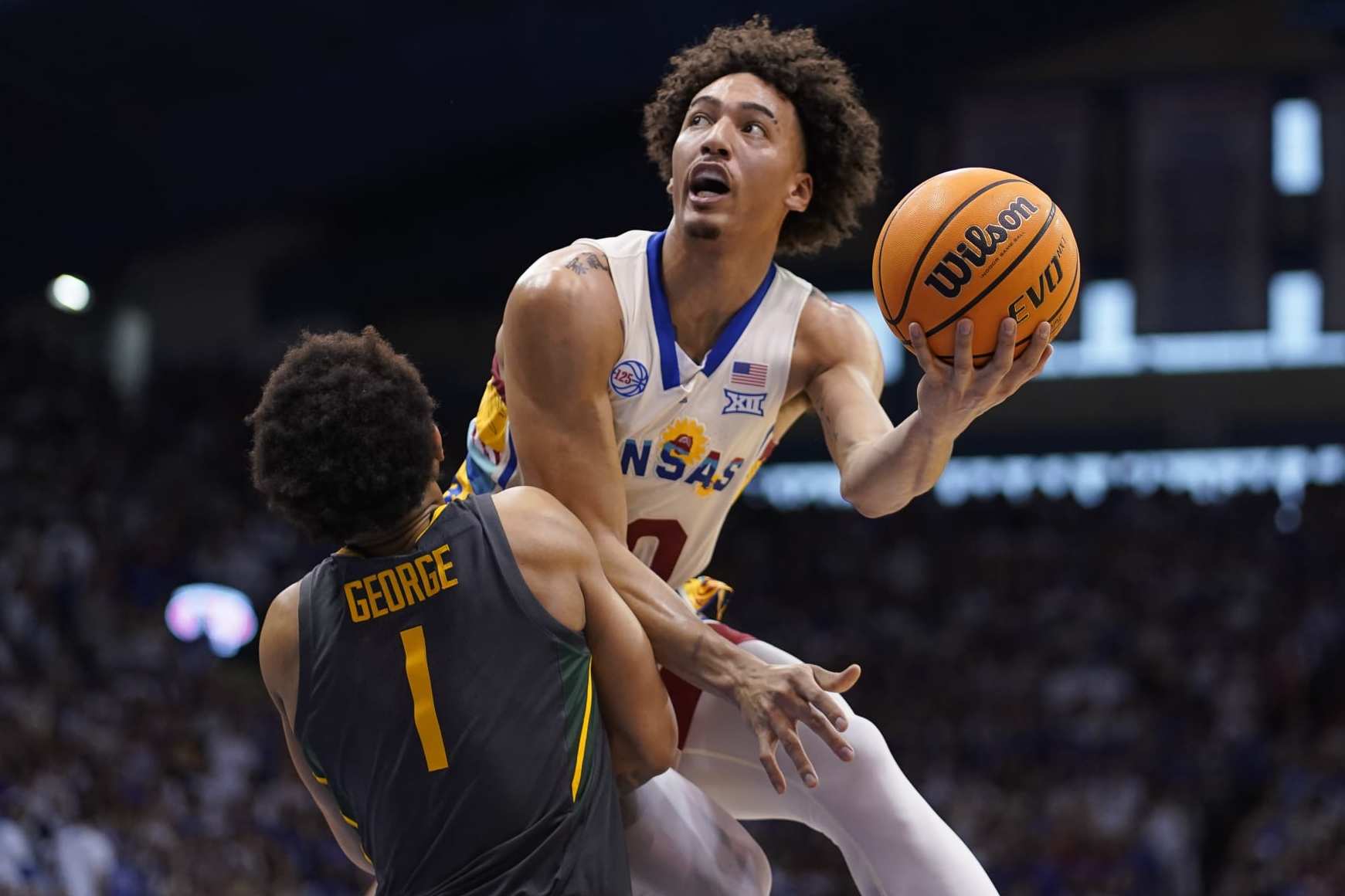 LAWRENCE, KANSAS - FEBRUARY 18: Jalen Wilson #10 of the Kansas Jayhawks lays the ball up over Keyonte George #1 of the Baylor Bears in the first half of the game at Allen Fieldhouse on February 18, 2023 in Lawrence, Kansas. (Photo by Ed Zurga/Getty Images)