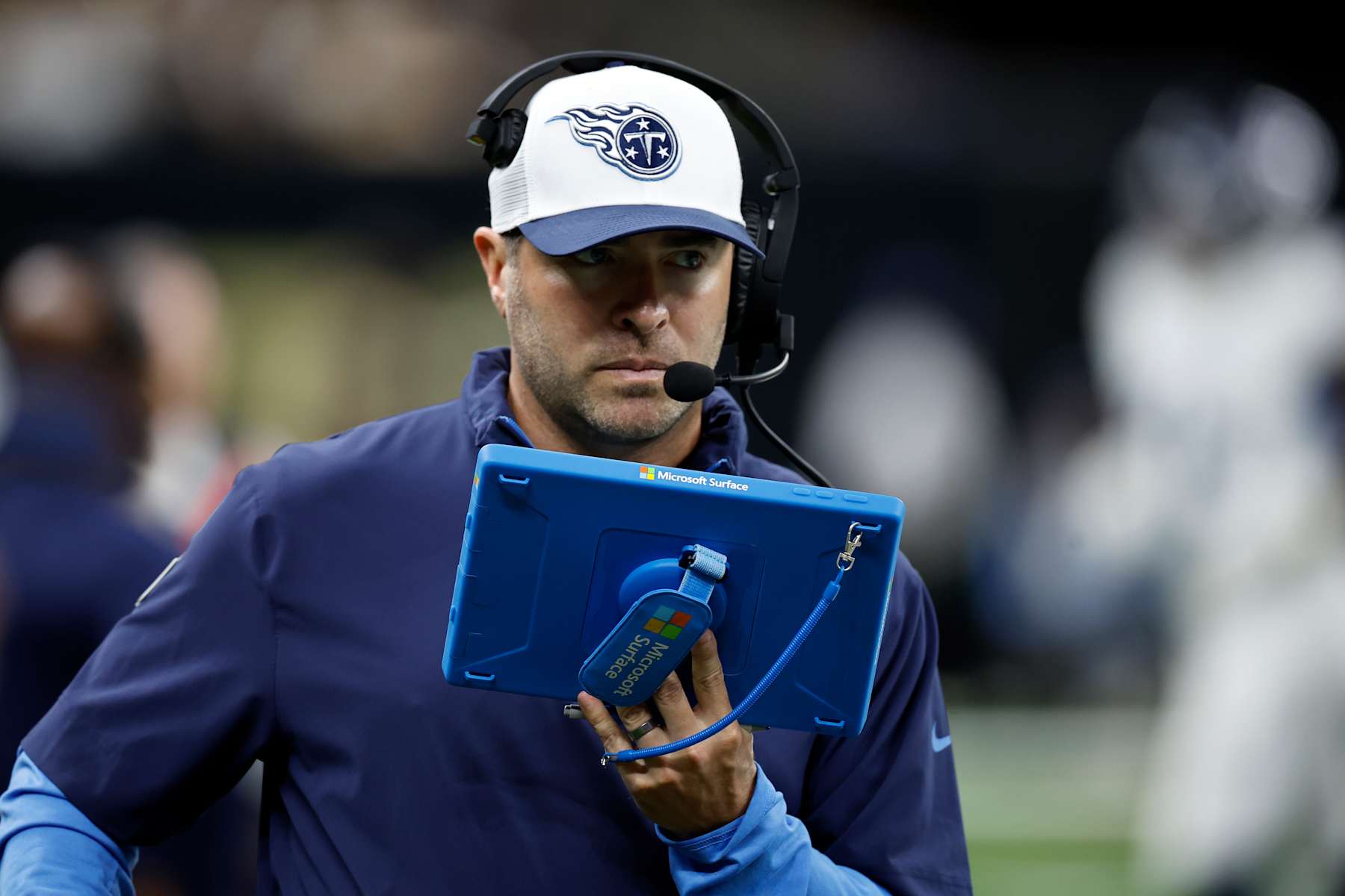 NEW ORLEANS, LOUISIANA - AUGUST 25: Head coach of the Tennessee Titans Brian Callahan looks at his Microsoft Surface tablet during the game against the New Orleans Saints at Mercedes Benz Superdome on August 25, 2024 in New Orleans, Louisiana. (Photo by Chris Graythen/Getty Images)