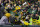 GREEN BAY, WISCONSIN - NOVEMBER 14: A.J. Dillon #28 of the Green Bay Packers celebates with fans after scoring a touchdown against the Seattle Seahawks during the fourth quarter at Lambeau Field on November 14, 2021 in Green Bay, Wisconsin. (Photo by Stacy Revere/Getty Images)