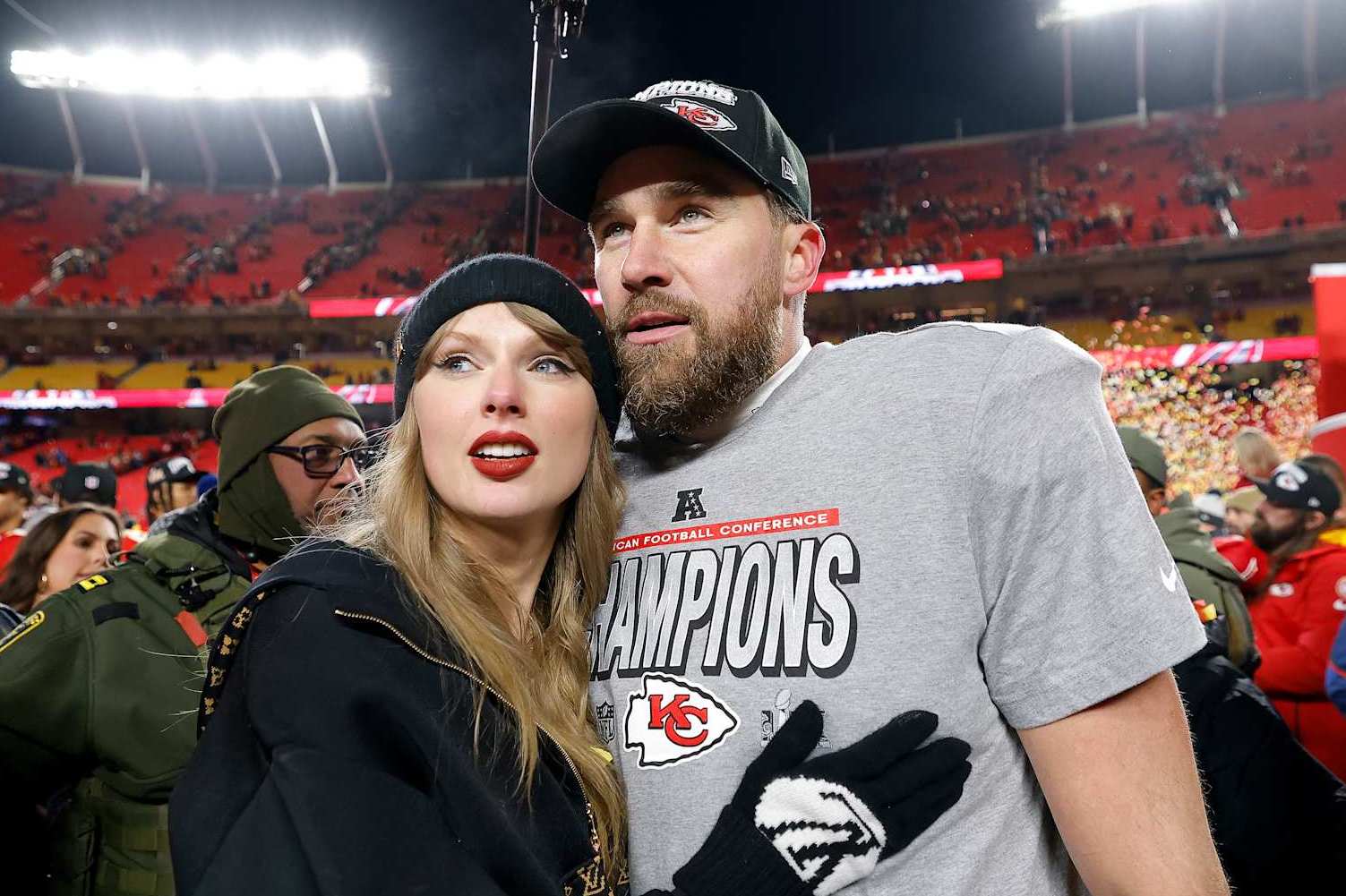 KANSAS CITY, MISSOURI - JANUARY 26: Taylor Swift celebrates with Travis Kelce #87 of the Kansas City Chiefs after defeating the Buffalo Bills 32-29 in the AFC Championship Game at GEHA Field at Arrowhead Stadium on January 26, 2025 in Kansas City, Missouri.  (Photo by David Eulitt/Getty Images)
