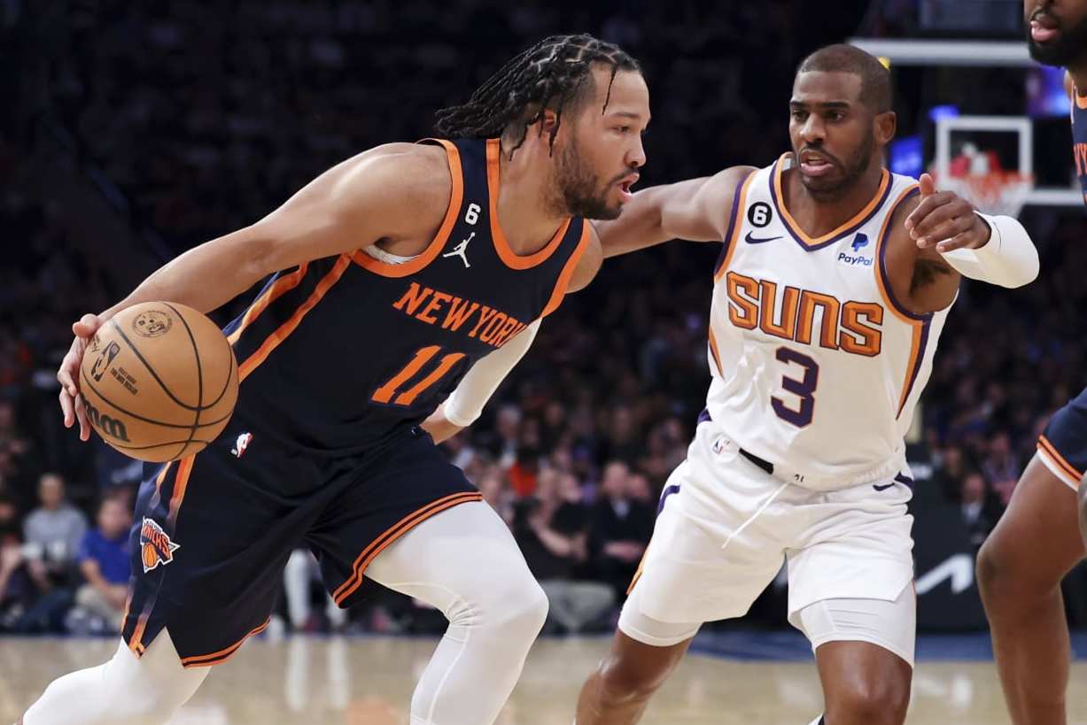New York Knicks guard Jalen Brunson (11) dribbles against Phoenix Suns guard Chris Paul (3) as New York Knicks center Mitchell Robinson (23) watches during the first half of an NBA basketball game, Monday, Jan. 2, 2023, in New York. (AP Photo/Jessie Alcheh) New York Knicks guard Jalen Brunson (11) dribbles against Phoenix Suns guard Chris Paul (3) as New York Knicks center Mitchell Robinson (23) watches during the first half of an NBA basketball game, Monday, Jan. 2, 2023, in New York. (AP Photo/Jessie Alcheh)