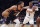 New York Knicks guard Jalen Brunson (11) dribbles against Phoenix Suns guard Chris Paul (3) as New York Knicks center Mitchell Robinson (23) watches during the first half of an NBA basketball game, Monday, Jan. 2, 2023, in New York. (AP Photo/Jessie Alcheh)