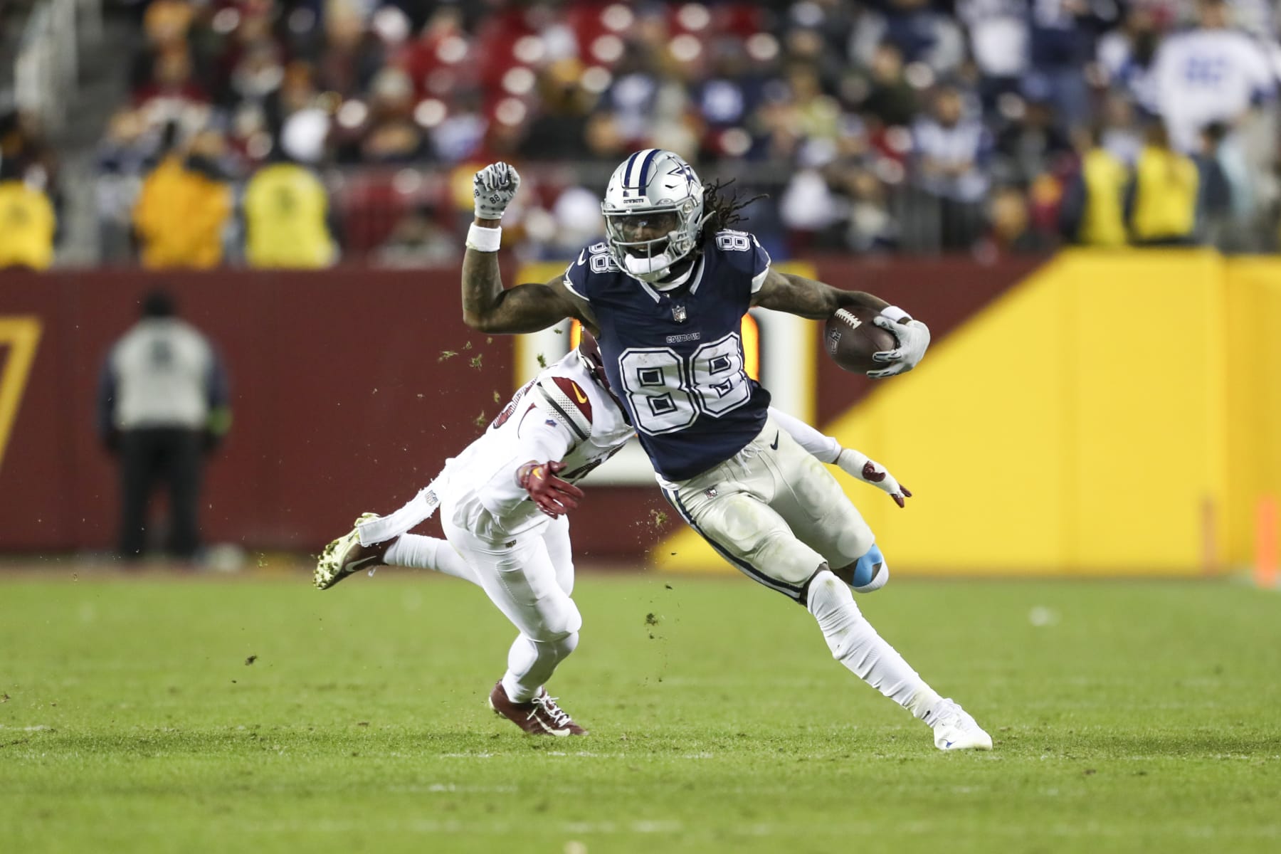 LANDOVER, MARYLAND - JANUARY 07: CeeDee Lamb #88 of the Dallas Cowboys evades a tackle during an NFL football game against the Washington Commanders at FedExField on January 7, 2024 in Landover, Maryland. (Photo by Kara Durrette/Getty Images)