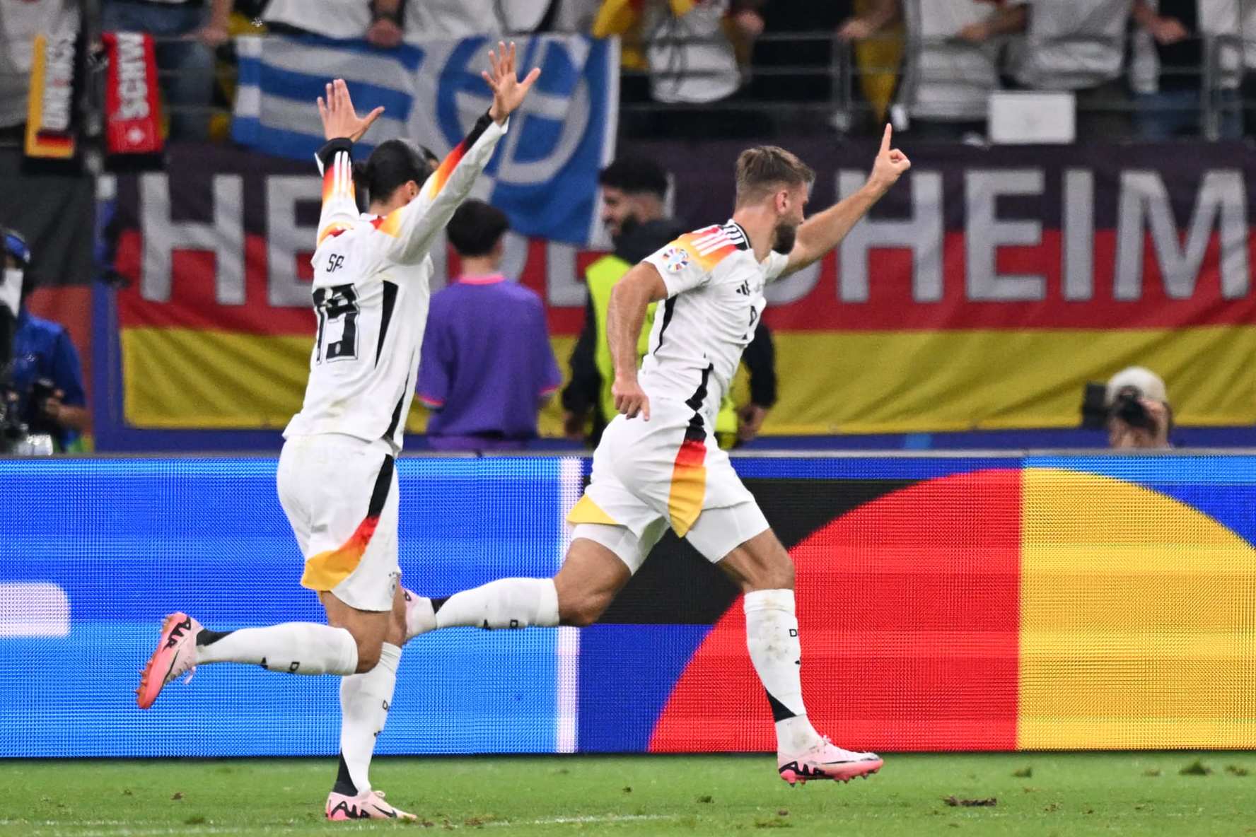 Germany's forward #09 Niclas Fuellkrug (R) celebrates scoring his team's first goal with his teammate Germany's midfielder #19 Leroy Sane during the UEFA Euro 2024 Group A football match between Switzerland and Germany at the Frankfurt Arena in Frankfurt am Main on June 23, 2024. (Photo by Kirill KUDRYAVTSEV / AFP) (Photo by KIRILL KUDRYAVTSEV/AFP via Getty Images)