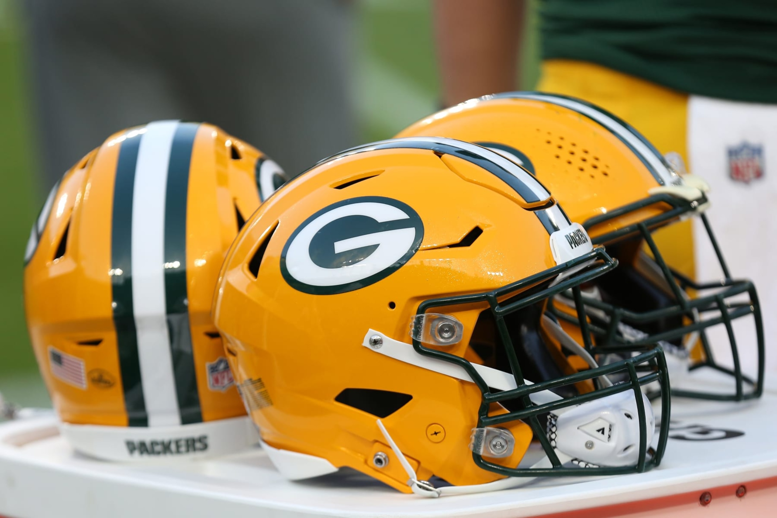 GREEN BAY, WI - AUGUST 19: Green Bay Packers helmets sit on the sideline during a game between the Green Bay Packers and the New England Patriots on August 19, 2023 in Green Bay, WI. (Photo by Larry Radloff/Icon Sportswire via Getty Images) GREEN BAY, WI - AUGUST 19: Green Bay Packers helmets sit on the sideline during a game between the Green Bay Packers and the New England Patriots on August 19, 2023 in Green Bay, WI. (Photo by Larry Radloff/Icon Sportswire via Getty Images)