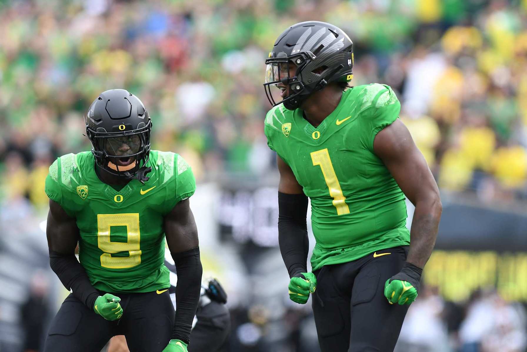 EUGENE, OR - SEPTEMBER 23: Oregon Ducks defensive end Jordan Burch (1) reacts to making a tackle with Oregon Ducks linebacker Jamal Hill (9) during a PAC-12 conference football game between the Colorado Buffaloes and Oregon Ducks on September 23, 2023 at Autzen Stadium in Eugene, Oregon. (Photo by Brian Murphy/Icon Sportswire via Getty Images)